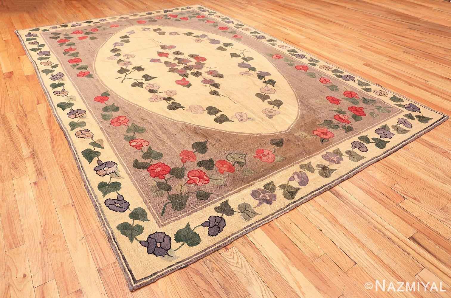 Antique American Hooked Rug, Country of Origin: America, Circa Date: 1920's. Size: 8 ft 2 in x 12 ft 6 in (2.49 m x 3.81 m)

A tableau of gorgeous morning glories spreads over this antique American rug. Red, white and blue flowers rest within the