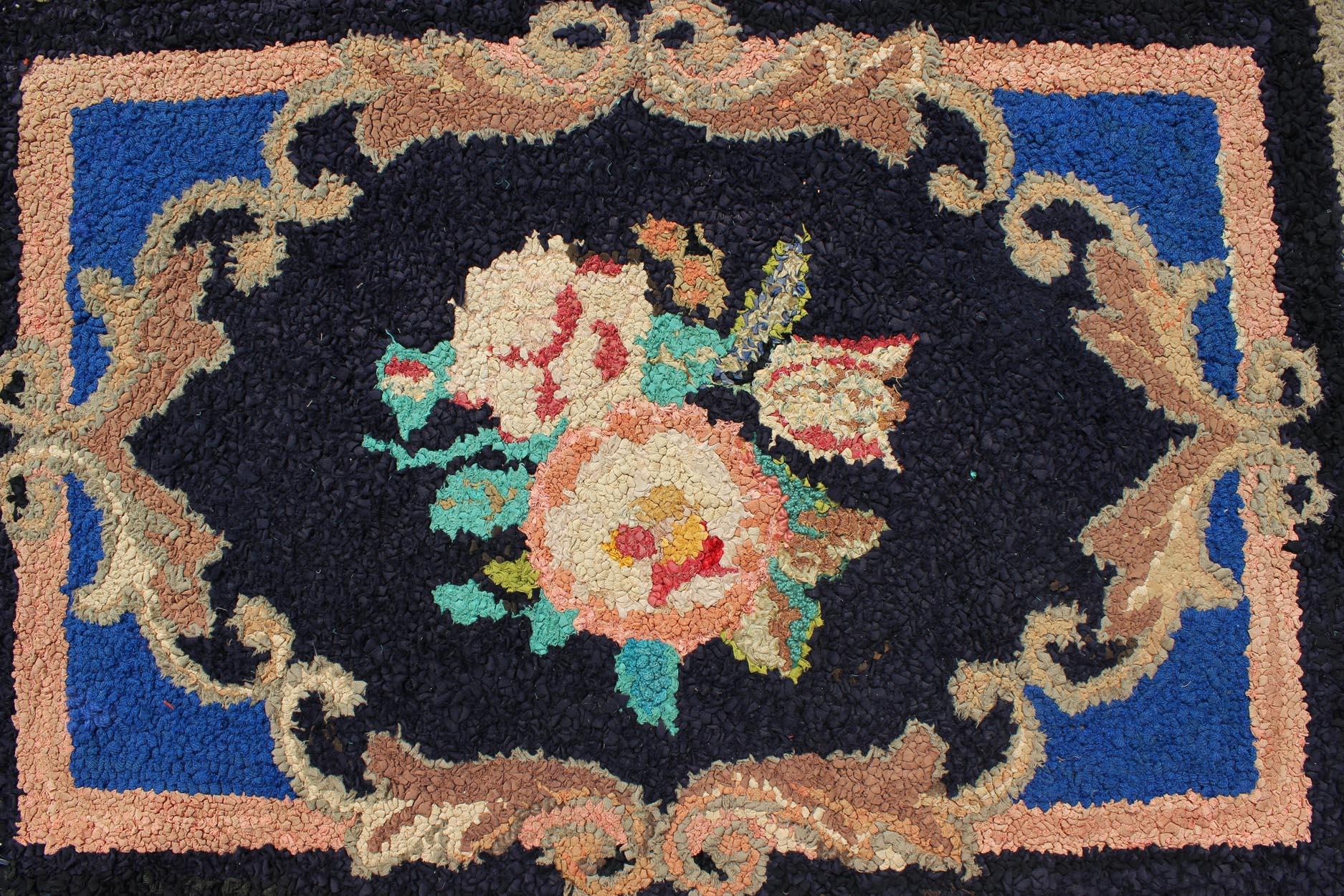 20th Century Antique American Hooked Rug with Large Floral Medallion in Black Background For Sale