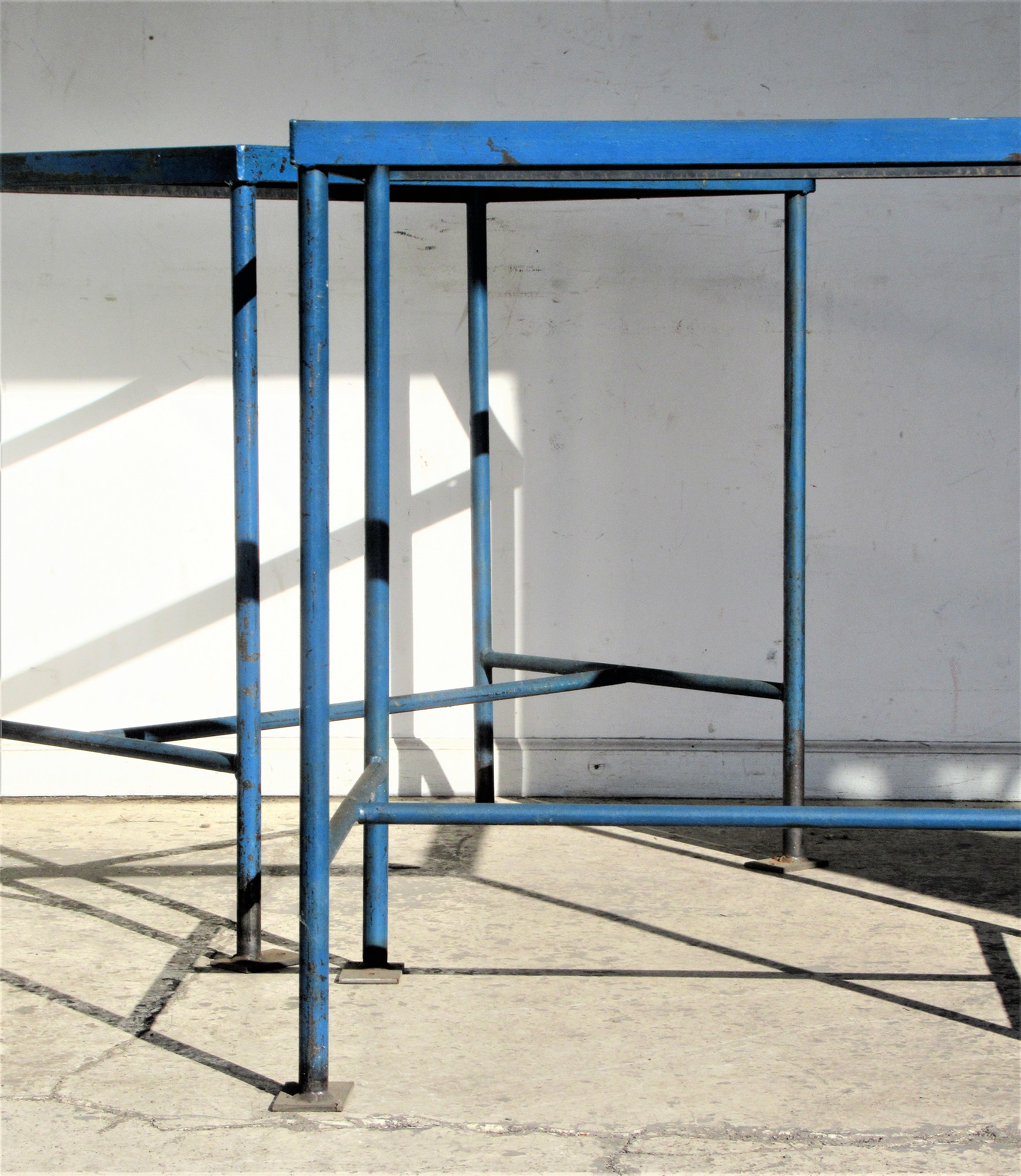 Pair of antique American industrial rectangular iron tables with great architectonic form and the best beautifully aged old original blue enamel painted surface. Direct from a long closed factory in Central New York State, Circa 1930 - 1940.