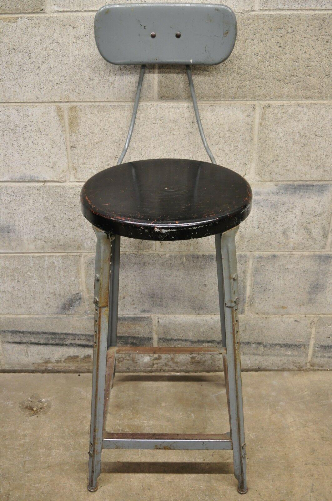 Antique American Industrial Gray Metal Drafting Stool Artist Work Chair. Item features adjustable height, black painted metal round seat, metal frame, distressed finish, very nice vintage item, quality American craftsmanship, great style and form.