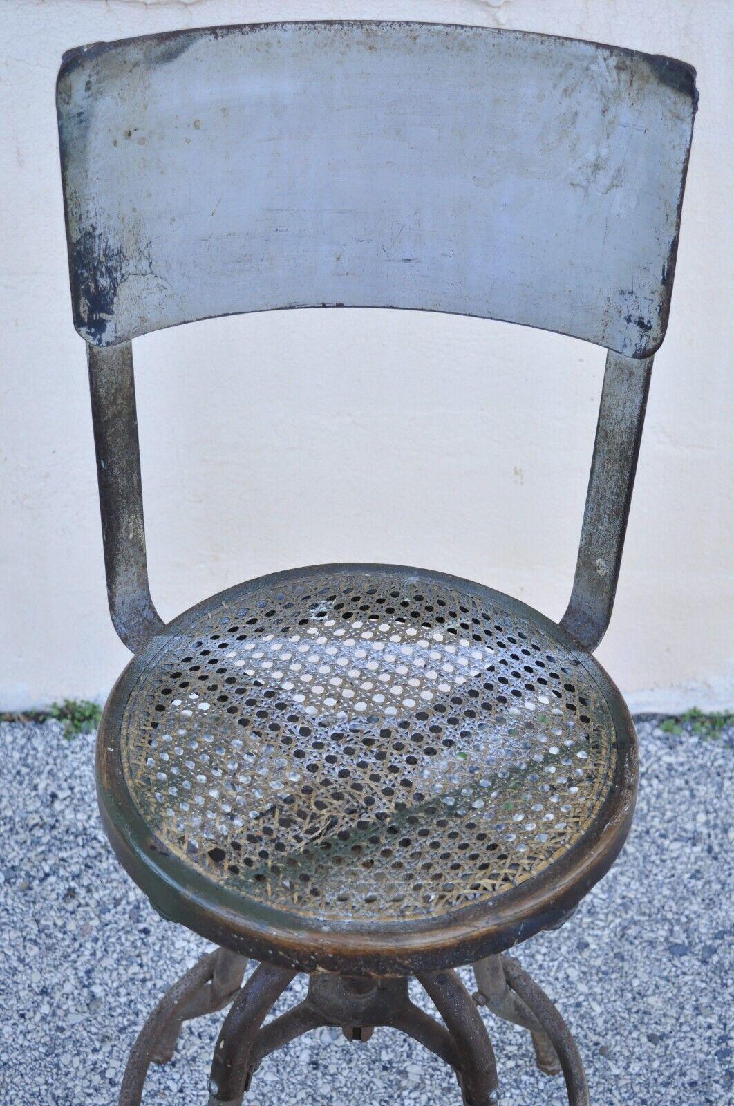 Antique American Industrial Metal Drafting Work Stool with Oak and Cane Seat In Good Condition For Sale In Philadelphia, PA