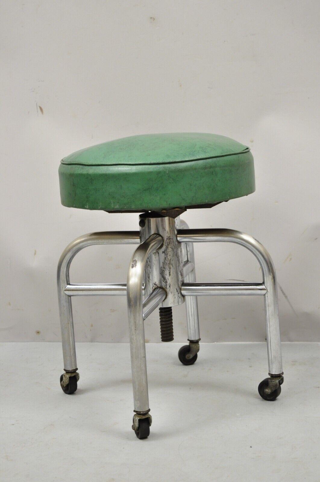 Antique American Industrial Metal Green Vinyl Rolling Work Stool Seat. item features round adjustable green vinyl seat, chrome metal base, rolling castors. Circa mid 20th Century. Measurements: 19-26