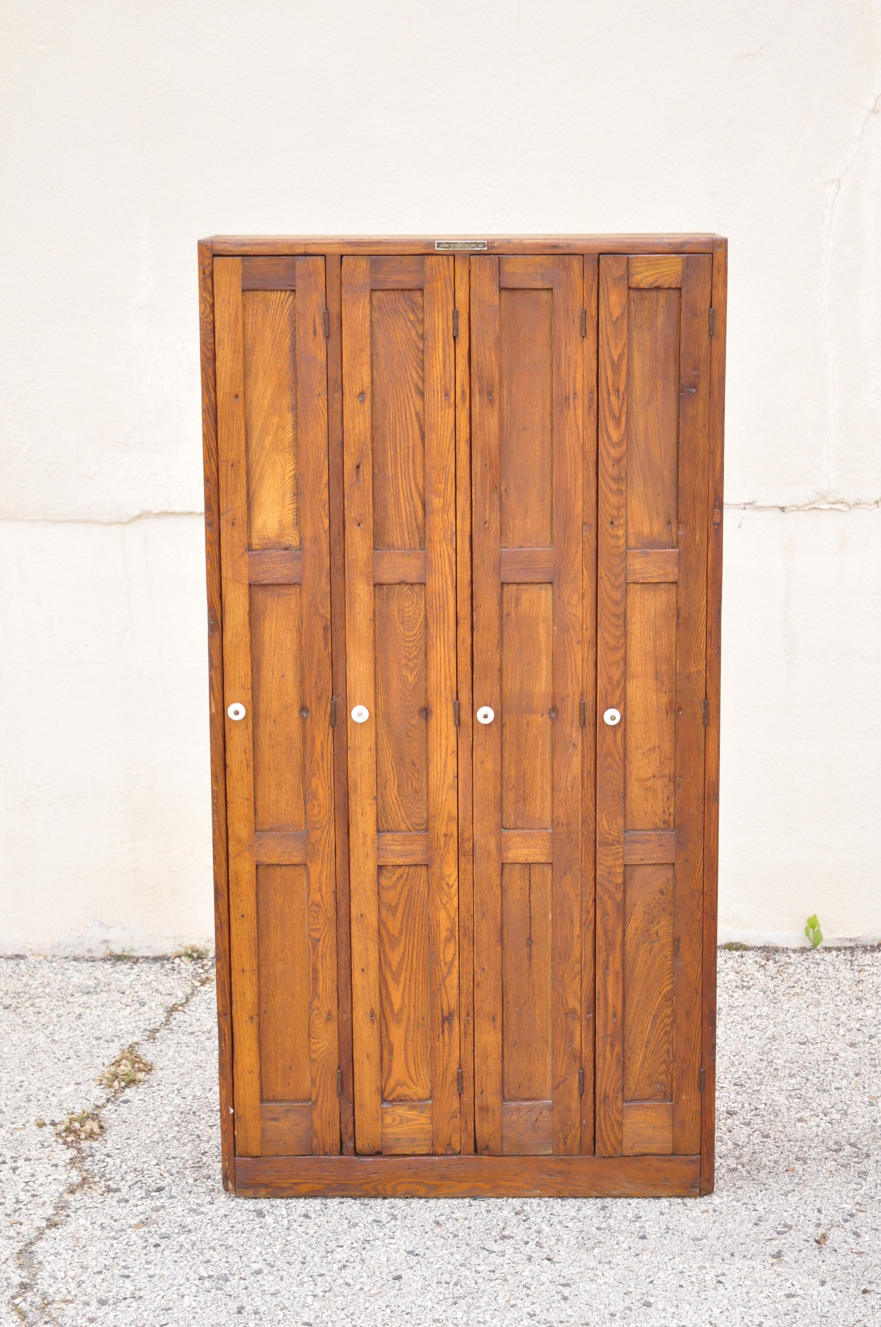 Antique American Industrial oak wood slim narrow file cabinet with angled file slots. Item features original metal tag reads, 
