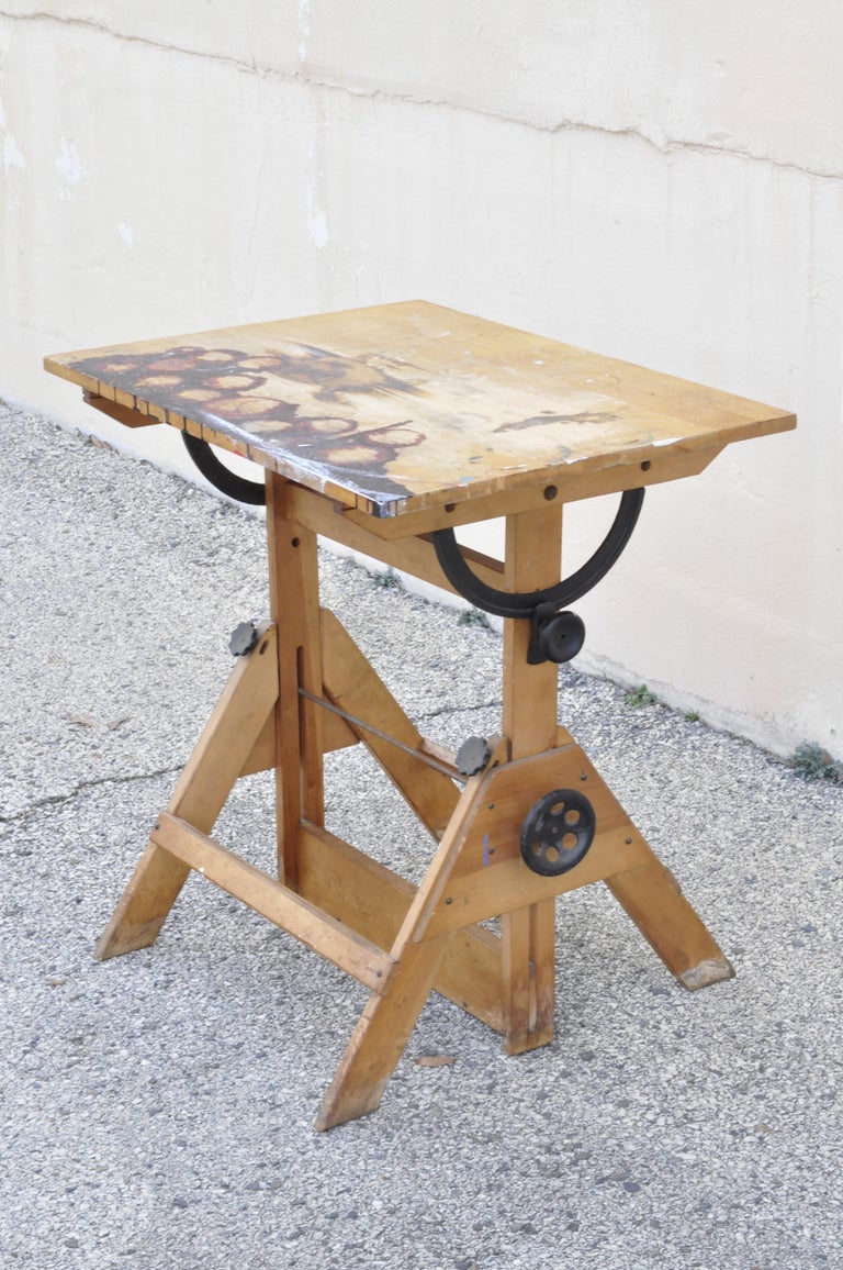 Antique American industrial small drafting table work desk cast iron hardware solid wood. Item features cast iron hardware, adjustable height and pivoting surface, nice smaller size, solid wood frame, quality American craftsmanship, great style and