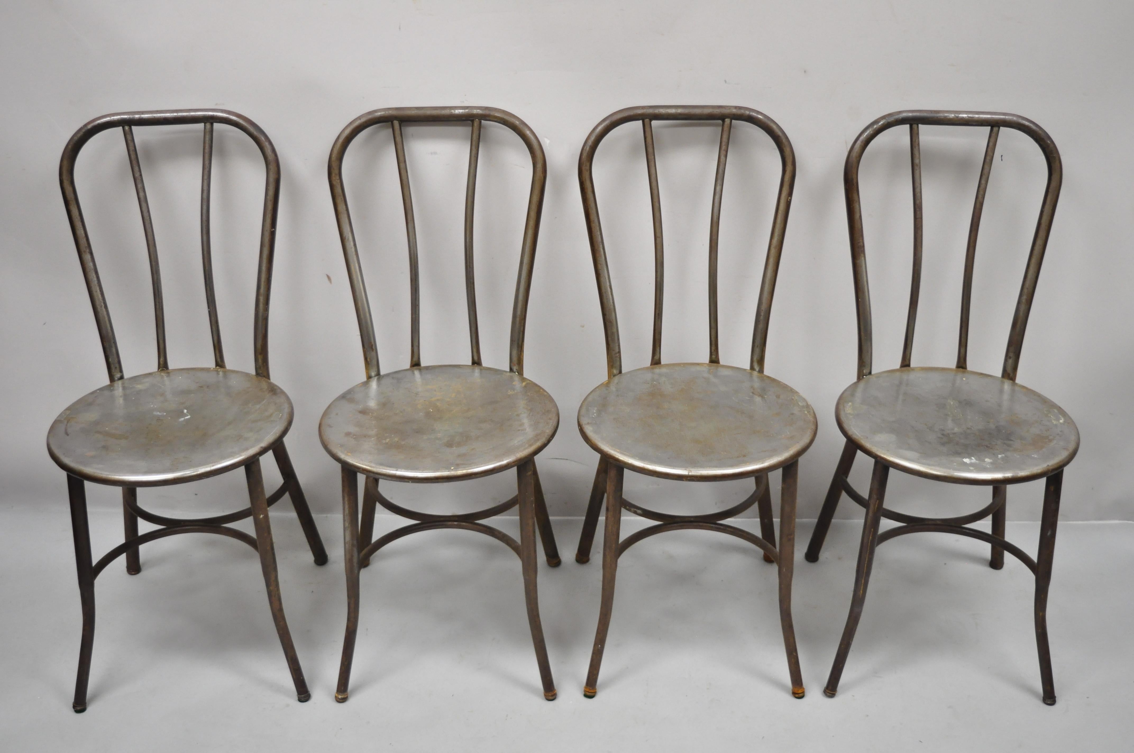 Antique American industrial steel metal ice cream parlor bistro side chairs, set of 4. Item features (4) side chairs, steel metal frames, round seats, original labels, tapered legs, very nice vintage set, quality American craftsmanship, great style