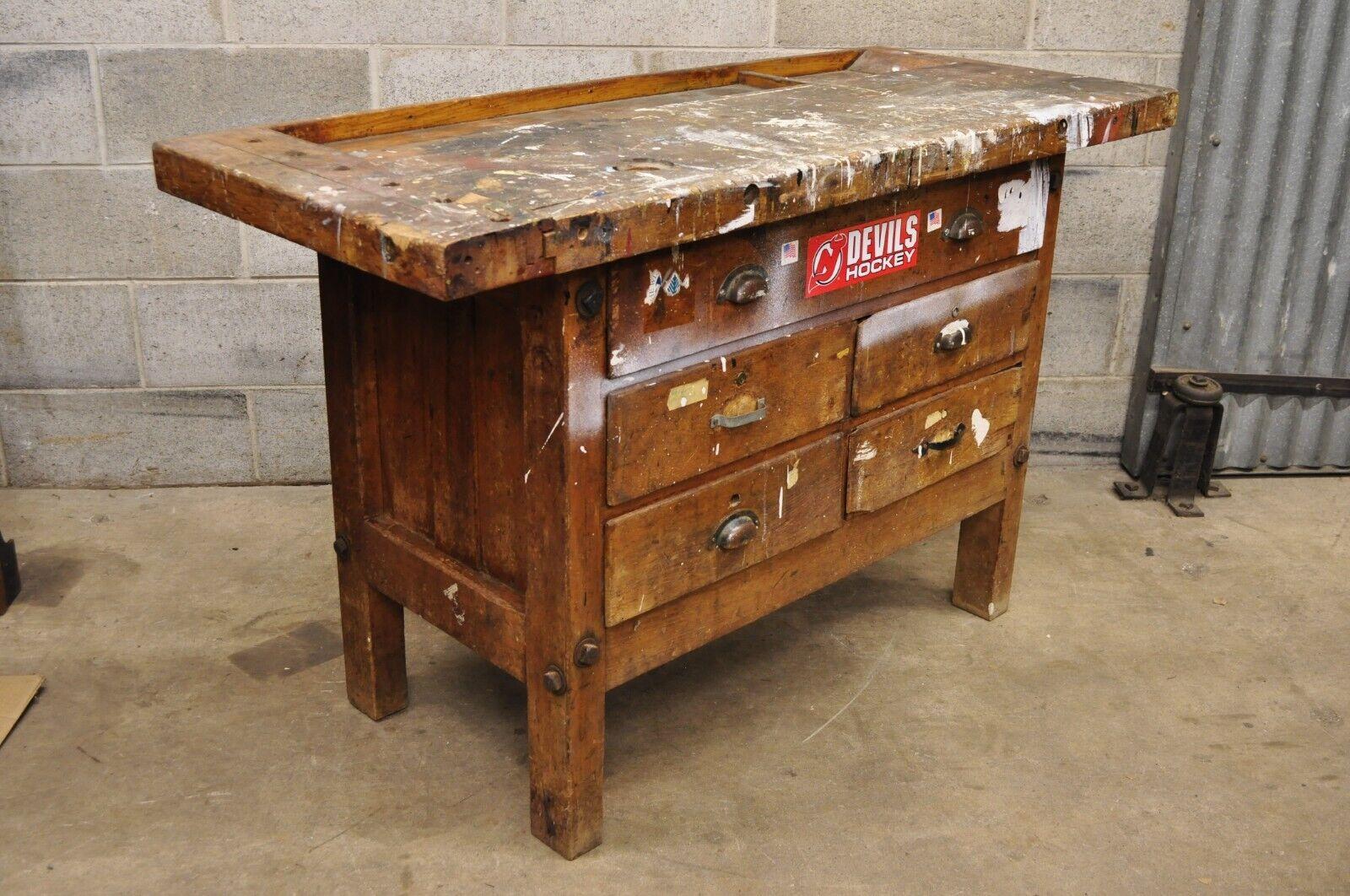 Antique American Industrial wood plank distress paint splatter work bench table. Item features a distressed finish with paint splatters, various metal handles, solid plank wood top with compartments, no key but unlocked, 5 drawers, very nice vintage