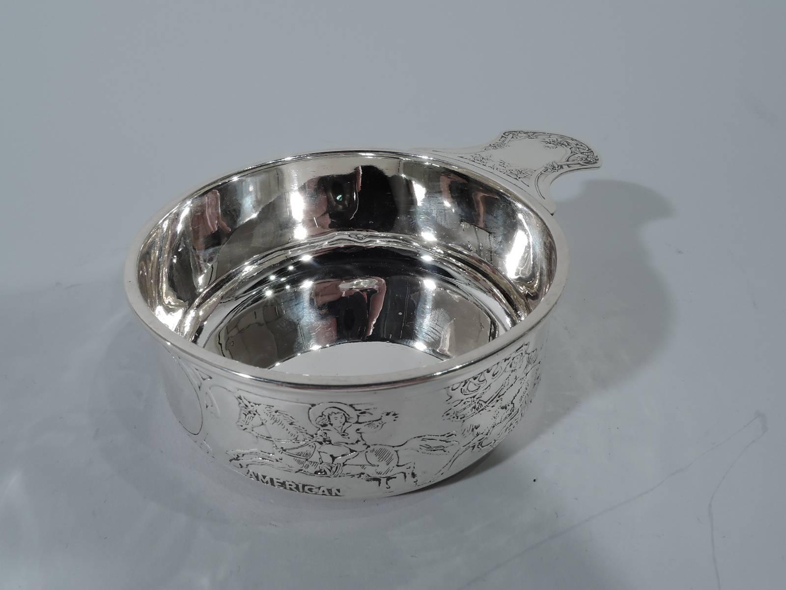 Sterling silver children of the world porringer. Made by Kerr in Newark, circa 1910. Slightly upward tapering sides, molded rim and solid waisted handle. On exterior is acid-etched frieze of children riding animals, including a horse, reindeer,