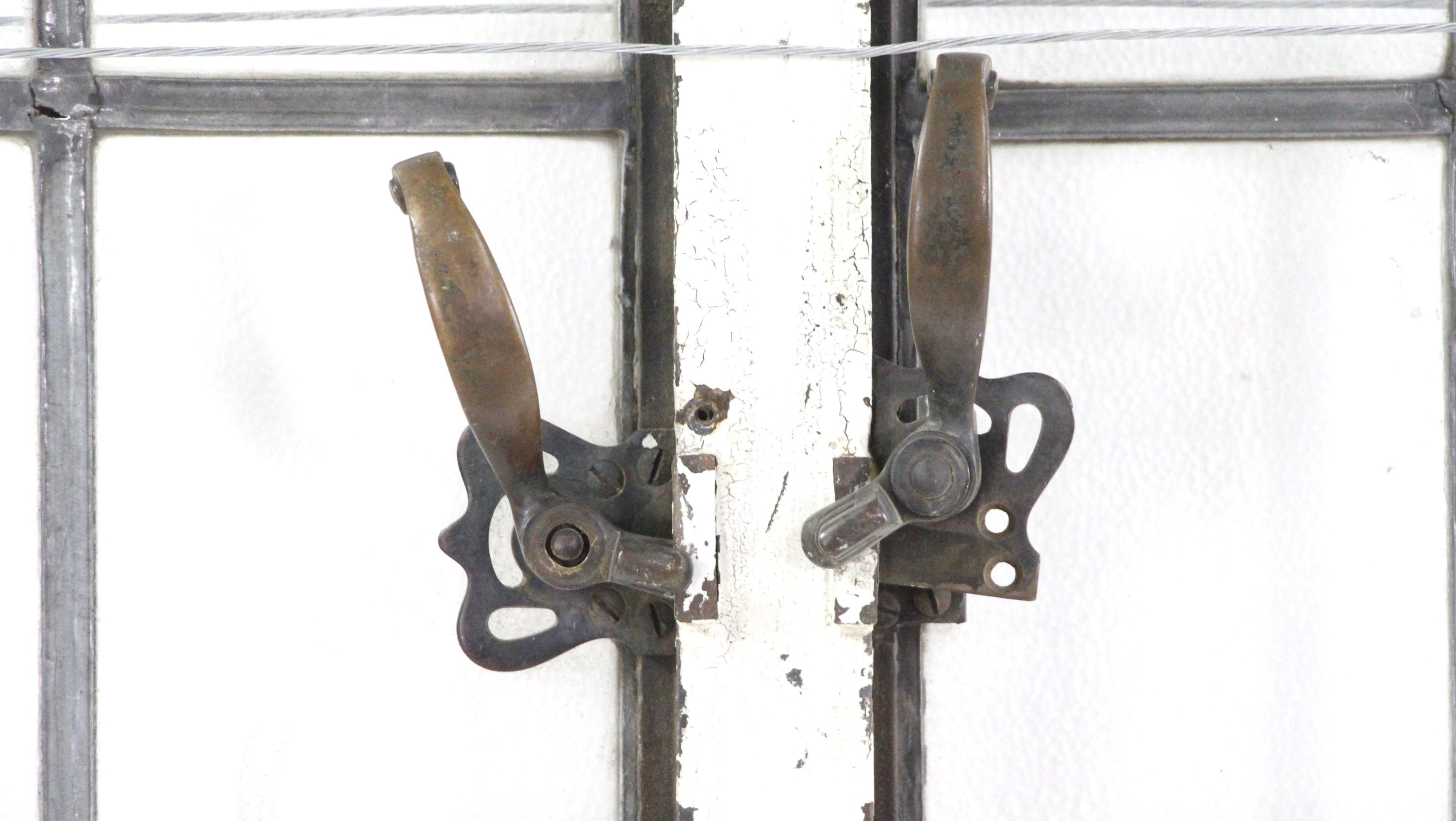 CIRCA 1900, doppeltes Bleiglasfenster mit 21 Scheiben, Stahlrahmen und originalen Bronzegriffen. Der Stahlrahmen ist auf einer Seite weiß lackiert und weist altersbedingten Rost auf. Der Preis gilt für ein Paar. Zum Zeitpunkt der Veröffentlichung