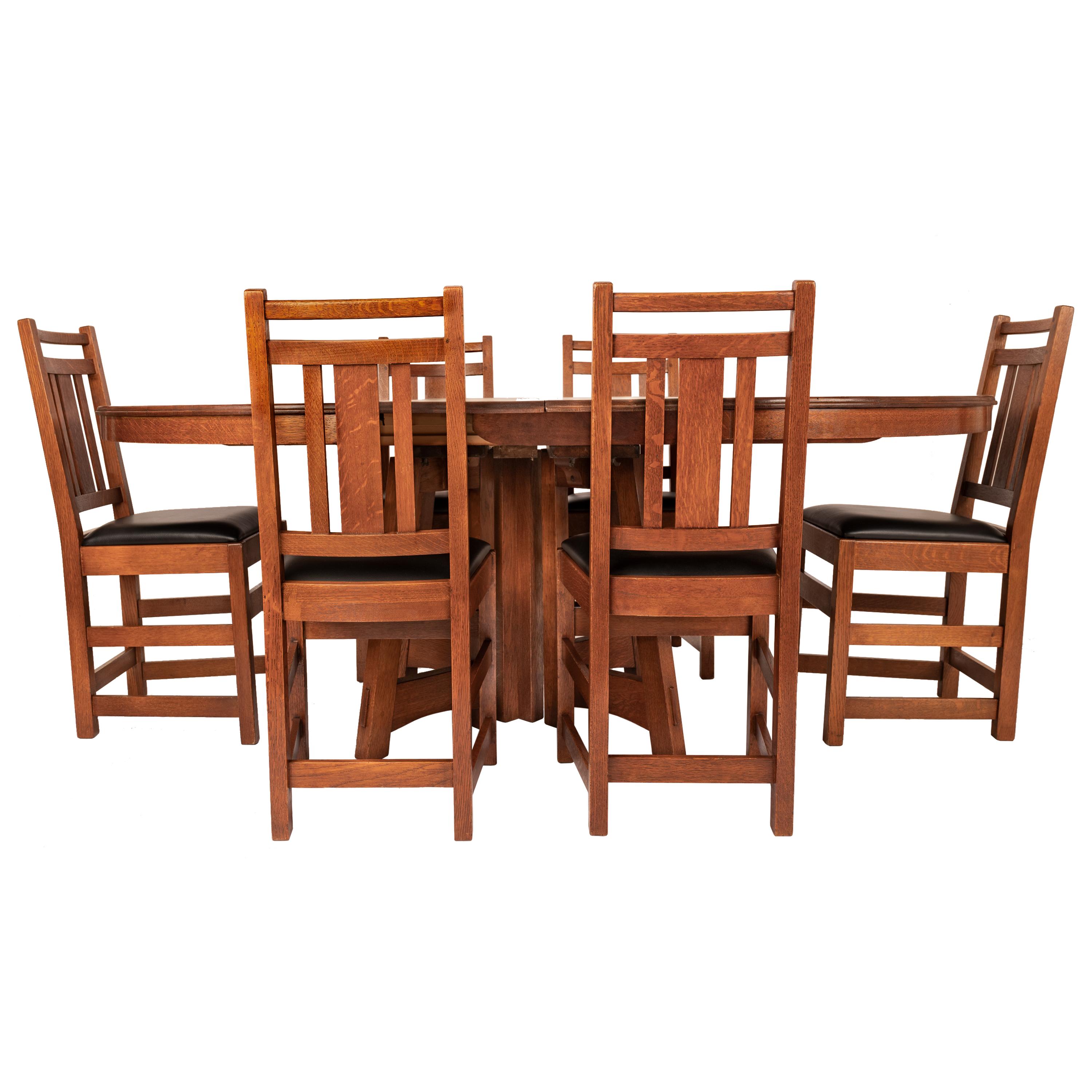 A very good antique American Mission/Arts & Crafts dining set by Charles Limbert, branded marks, circa 1905.
The set comprising a circular table model # 1408, with four original leaves and six original chairs, made from quarter sawn oak throughout.