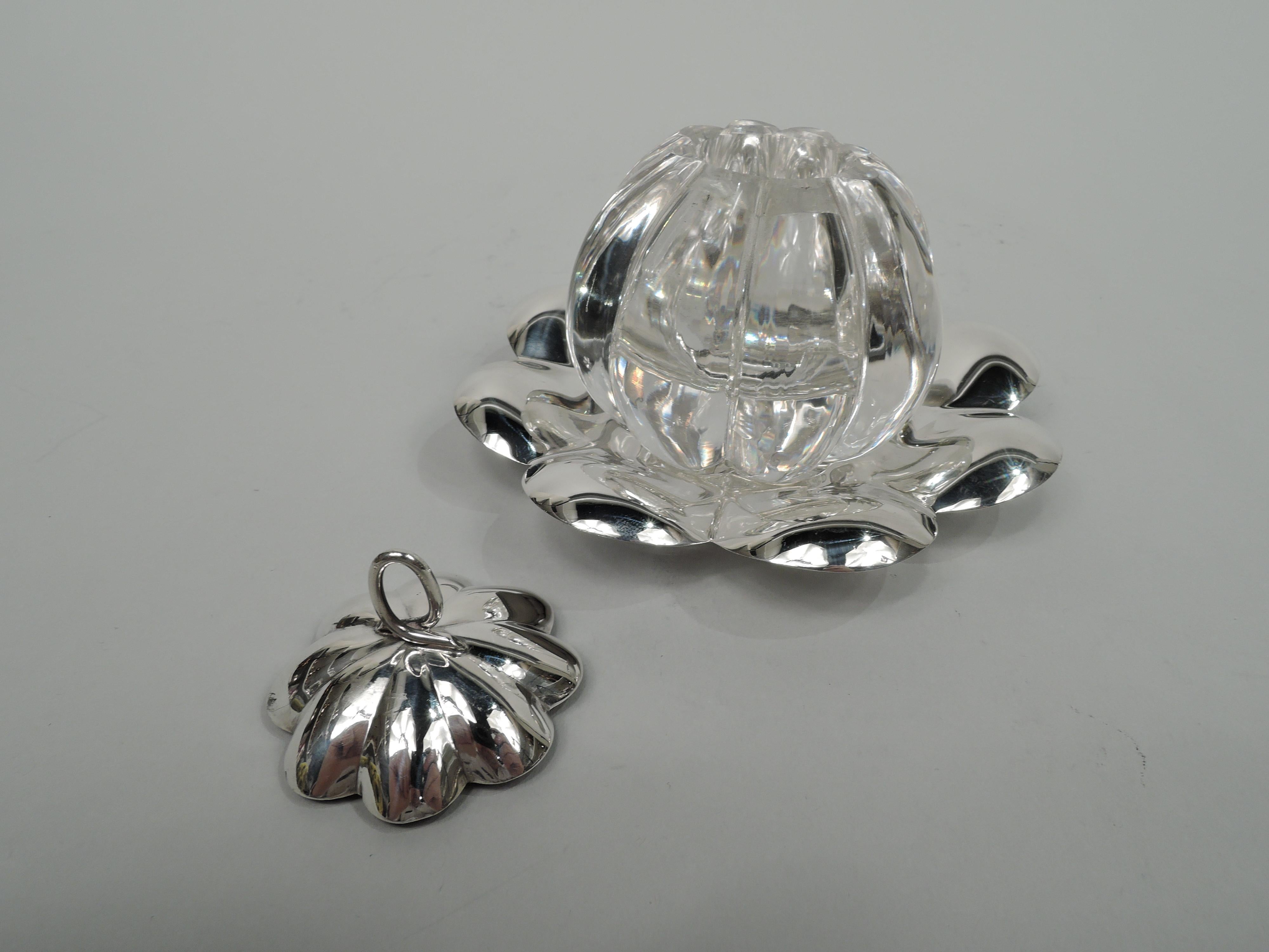 Modern sterling silver and glass inkwell on stand, circa 1920. Lobed melon-form glass bowl; sterling silver cover domed with overlapping ovoid ring finial. stand has well and large lobing. stand and cover marked “Sterling”. Total weight (silver