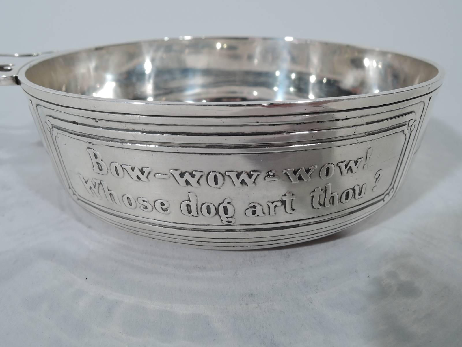 Edwardian sterling silver Mother Goose porringer. Made by Tiffany & Co. in New York. Bowl has straight sides with open tree handle. Acid-etched on exterior in pictures and text is Little Tom Tucker. In one frame: Bow-wow-wow! Whose dog are though?