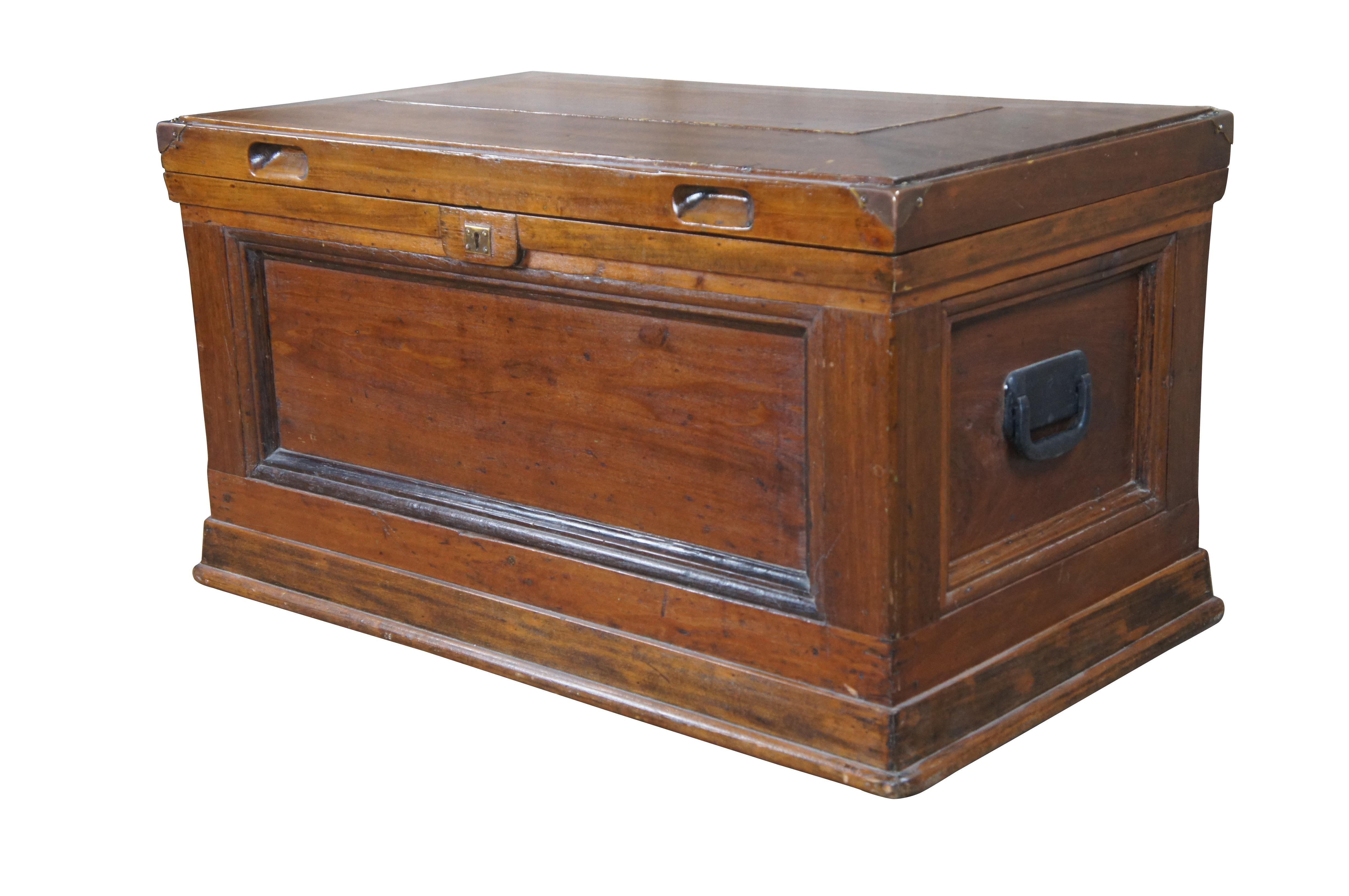 Late 19th to early 20th century Oak carpenters tool chest or trunk.  Features a rectangular form with beveled top, brass banded corners and inset handles along the front.  The body of the trunk is paneled with a double molding and iron handles along