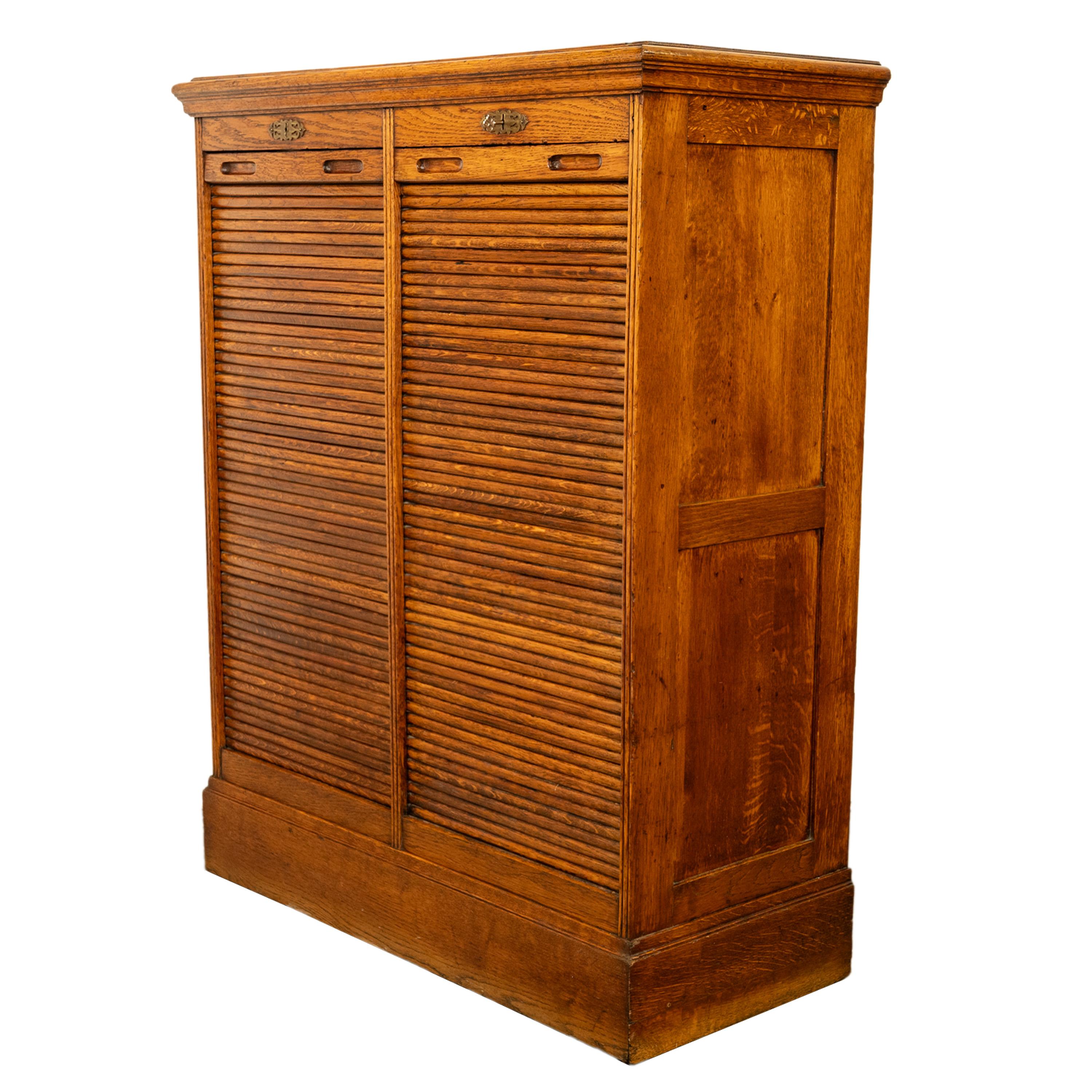 A good antique American oak double tambour roll top locking filing cabinet, circa 1910.
The cabinet having two tambour roll fronts that open and move with ease (please see video attached) , the original key is present, each tambour roll encloses