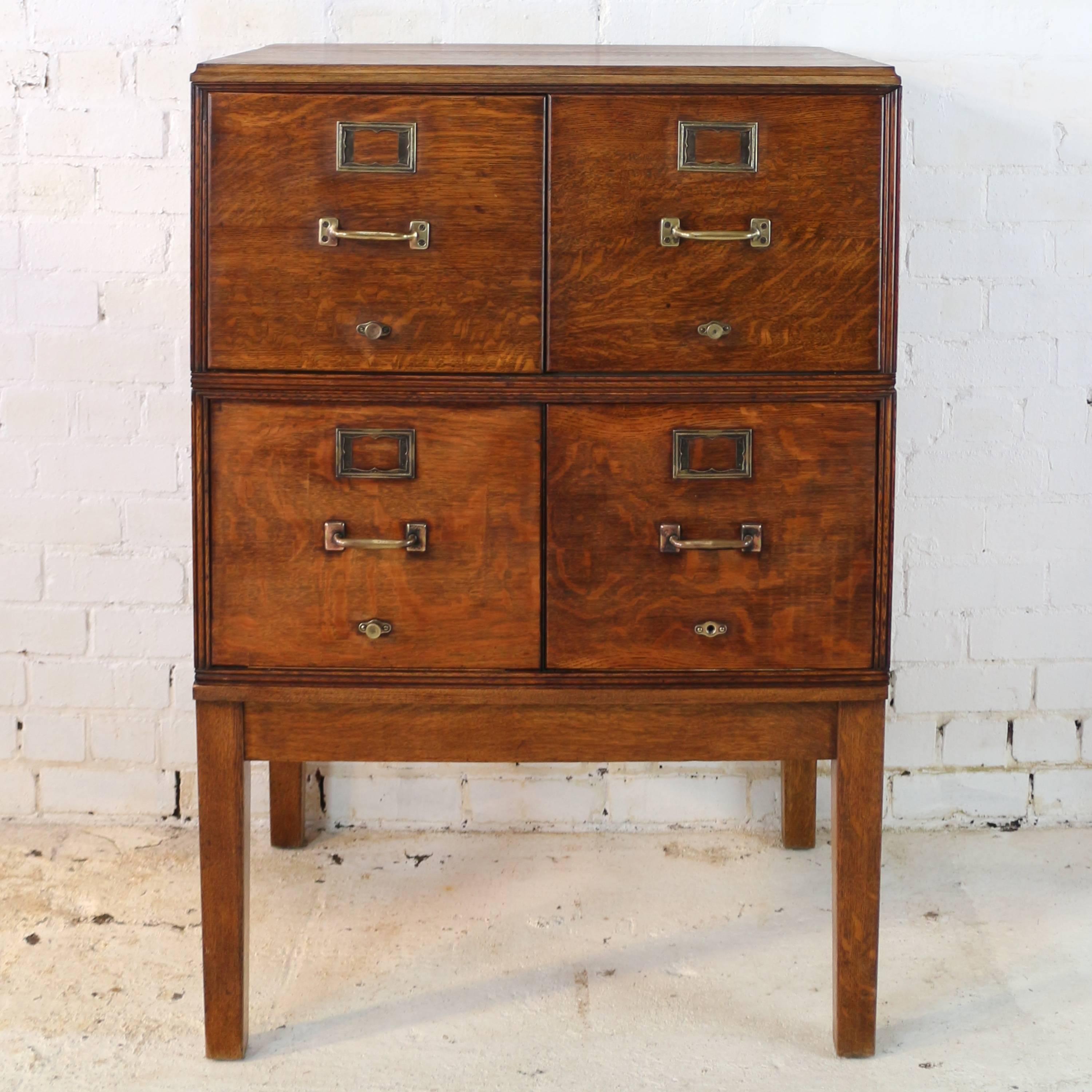 A rare double width antique quarter-sawn oak filing cabinet dating to circa 1910. Made by Yawman and Erbe, a leading maker of early filing systems, it has four large drawers with original brass handles, name plates, rods for guides/indexes and