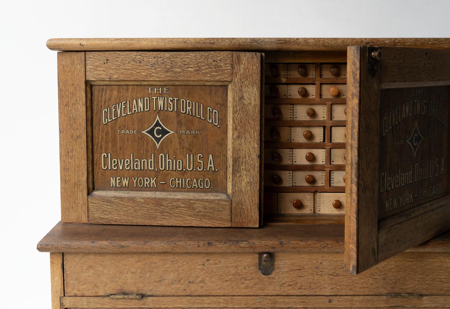 ANTIQUE OAK CABINET 

Made in the US as an in-store advertising piece for hardware stores to store and sell drill bits for ‘The Cleveland Twist Drill Co. Trade Mark, Clevland Ohio U.S.A. New York - Chicago.’  - written in a gilt typeface with a