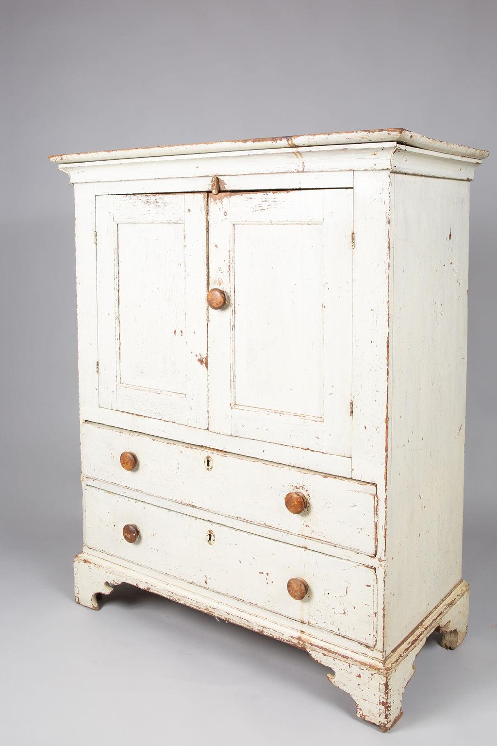 Hudson valley small Chippendale white painted cupboard. Fitted with a pair of cupboard doors opening to one shelf, above two drawers.