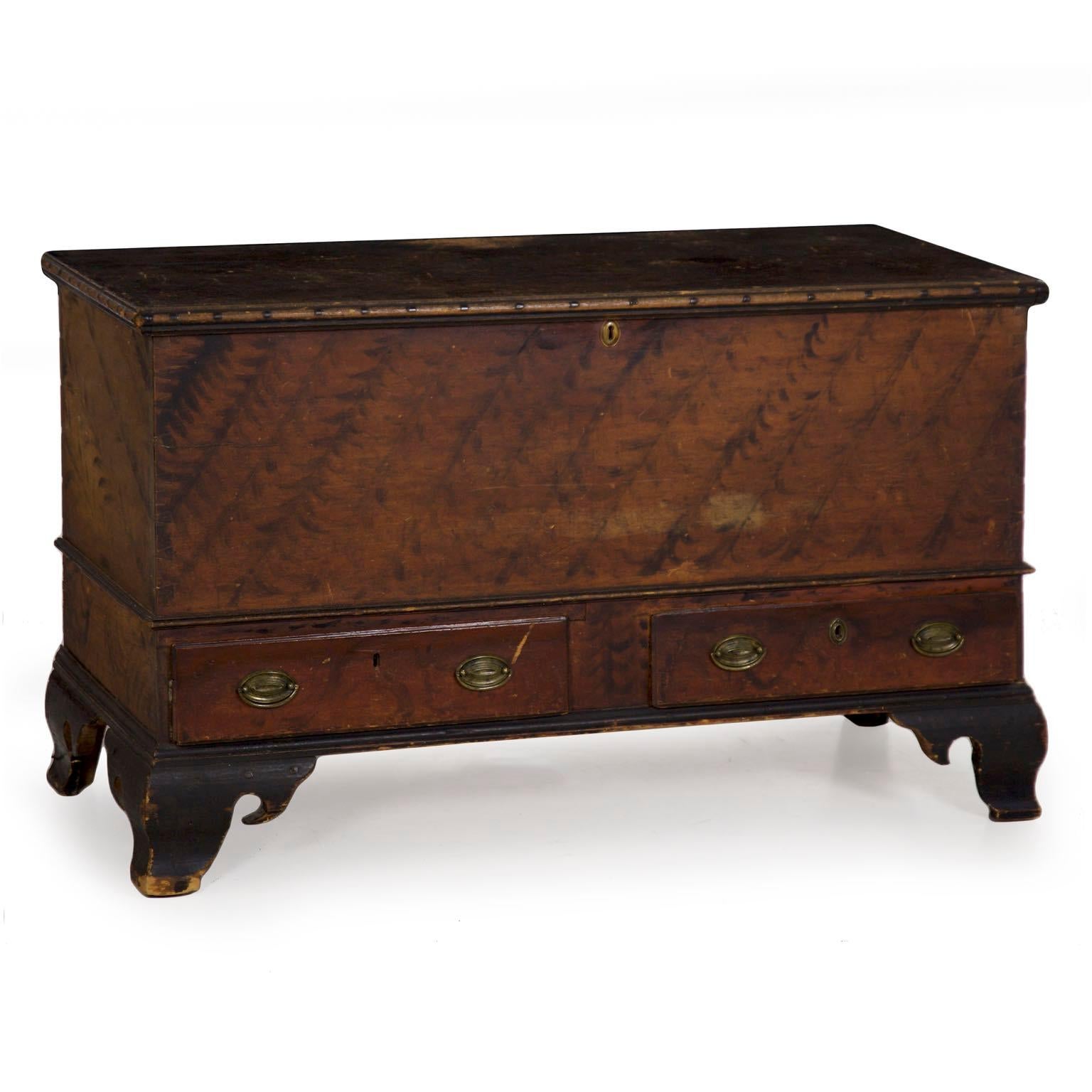 A well preserved dower chest from the first quarter of the 19th century, the beautifully oxidized painted finish is original throughout over the pine primary woods. Yellow pine is used almost exclusively throughout the case, the only notable