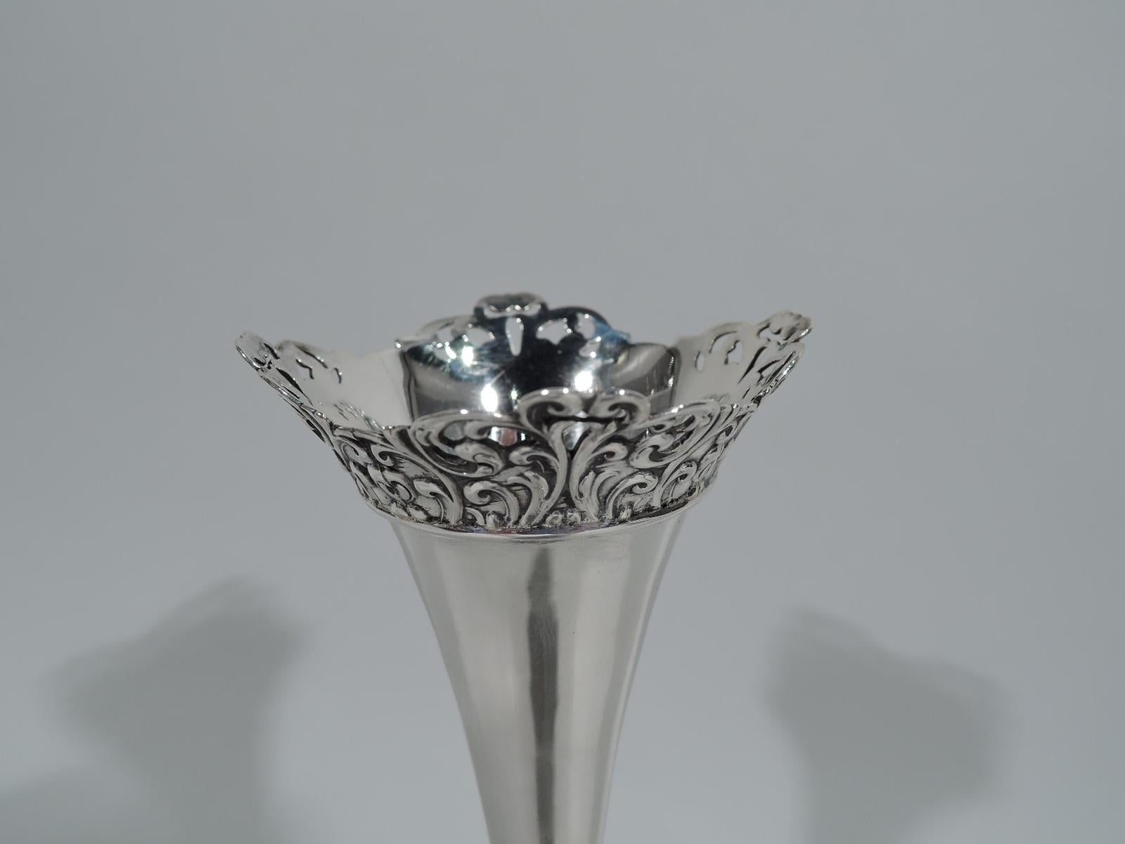 Victorian sterling silver bud vase. Made by Whiting in New York, circa 1890. Tall and narrow cone mounted to domed foot with loose and vertical scrolls and flowers. Rim scrolled and asymmetrical with pierced same. Hallmark includes no. 5266. Weight: