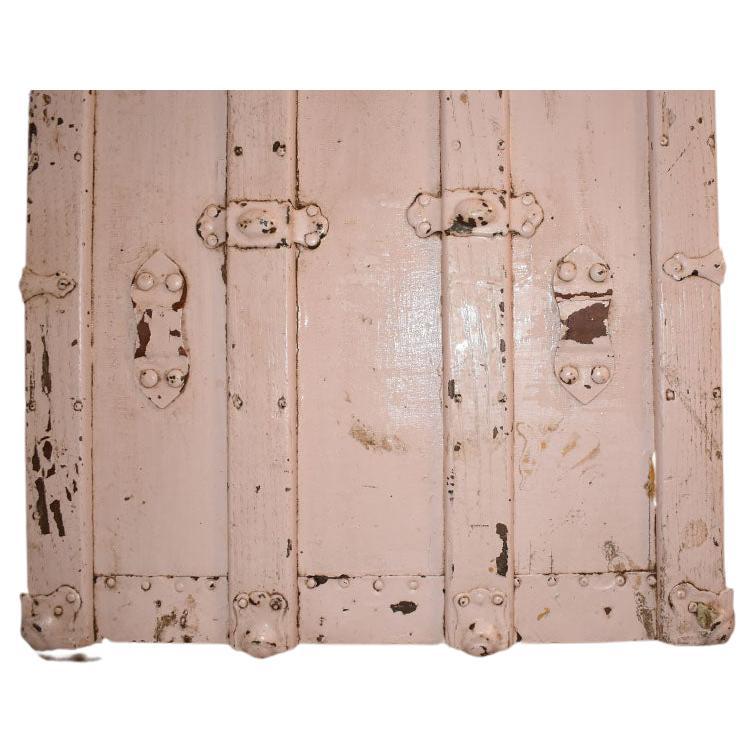 An early 19th Century wood steamer trunk. A fabulous antique trunk painted in pale baby pink. Created from wood, the sides are reinforced with wood and metal clasps. Leather straps flank each side as well as over the top. The interior of the trunk