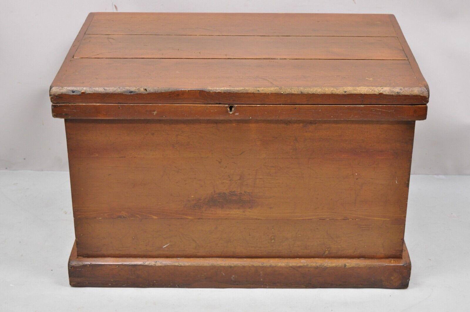 Antique American Primitive brown wooden blanket chest trunk. Item features cast iron hardware, solid wood construction, distressed finish, no key, but unlocked, very nice antique item, great style and form. Circa Early 1900s. Measurements: 21.5