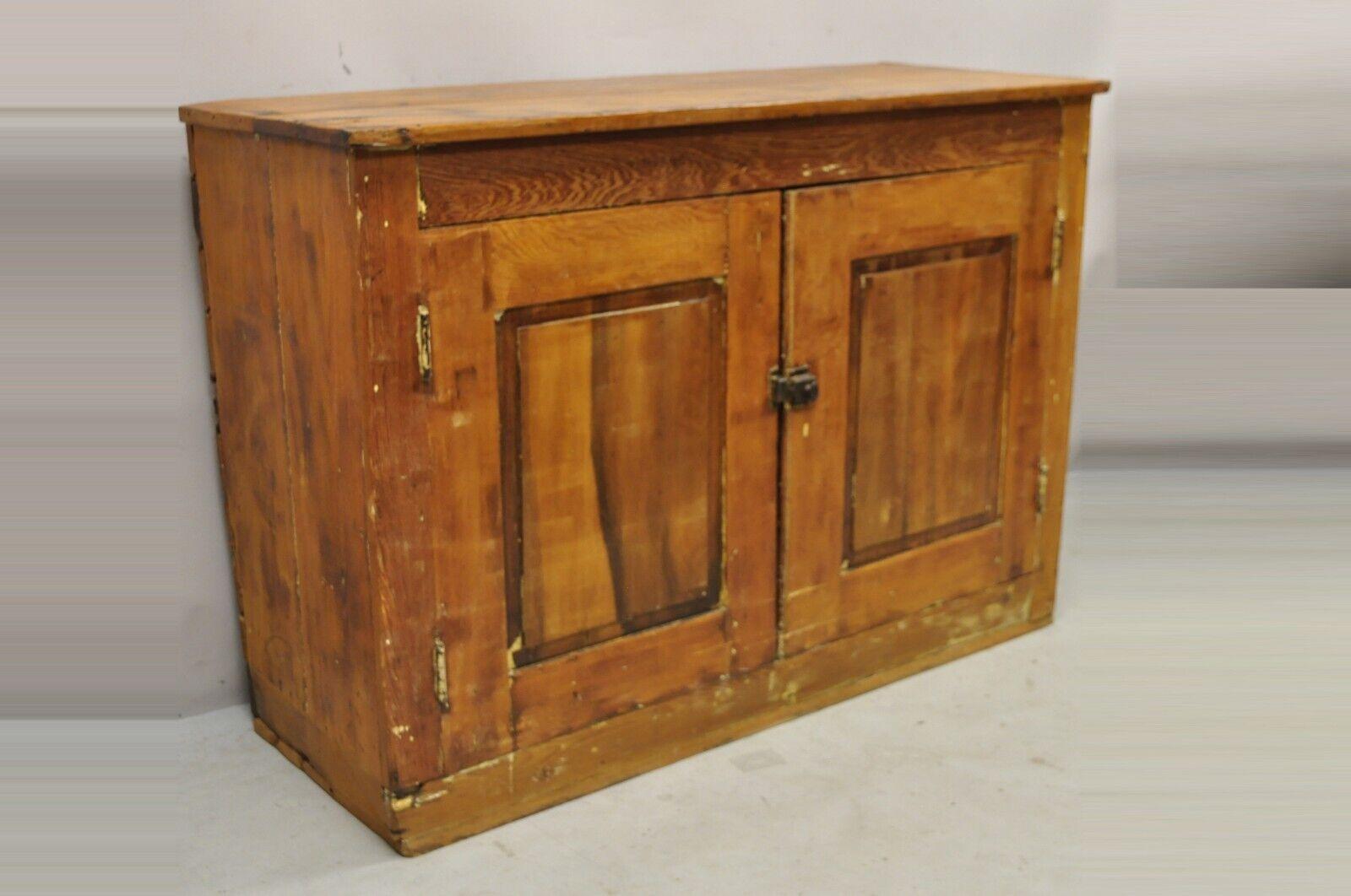 Antique American Primitive Country pine wood 2 Door cupboard Hutch Cabinet. Item features plank wood backing, solid wood construction, beautiful wood grain, distressed finish, 2 swing doors, 1 wooden shelf, very nice antique item, quality American