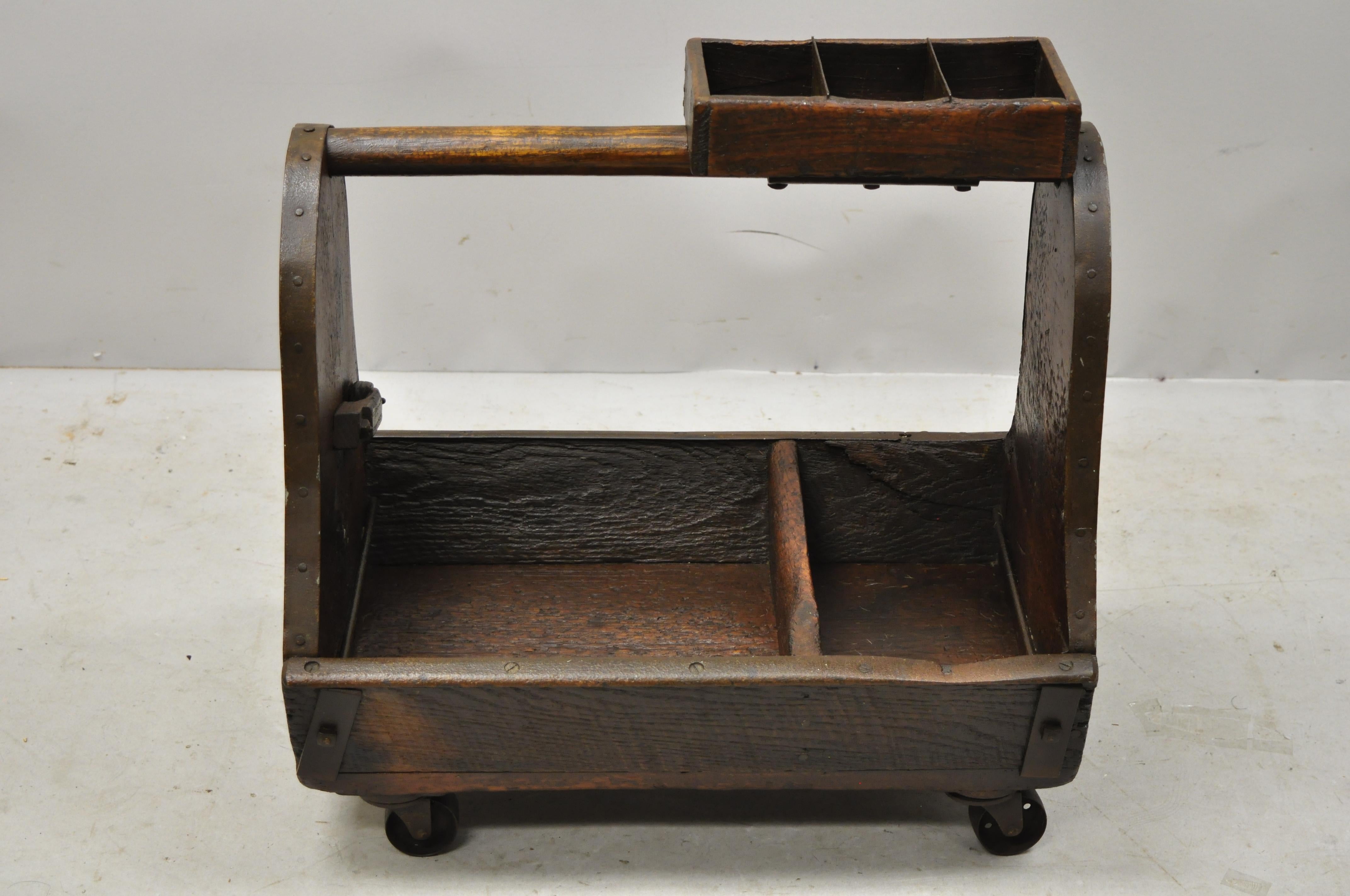 Antique American Primitive wood and iron carpenters cobblers tool box work caddy on wheels. Item features remarkable authentic patina, cast iron rolling wheels, multiple compartments, solid wood construction, beautiful wood grain, very nice antique