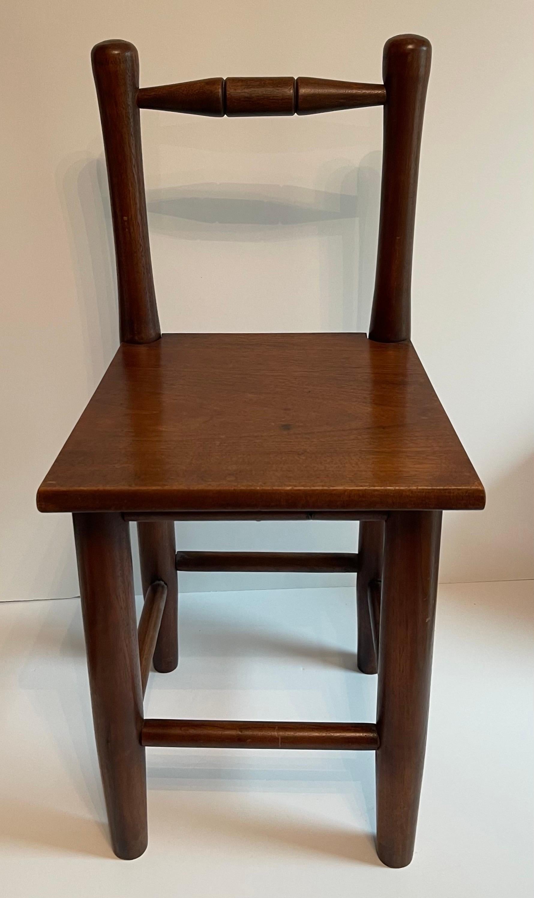 Antique American primitive style children’s chair or decorative accent chair. Solid wood chair that is heavy and well made for its size. No makers mark or signature. 