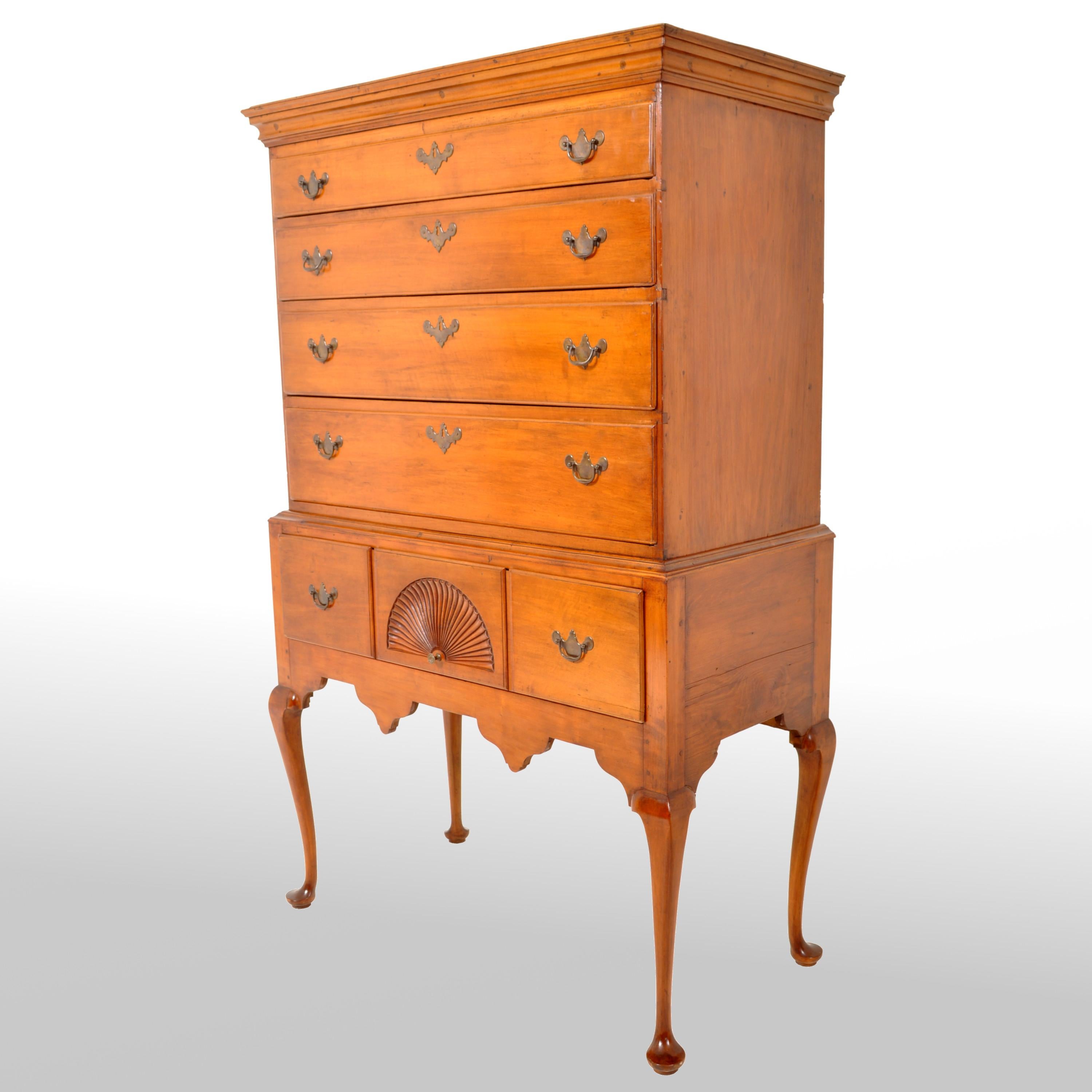 A fine antique American maple highboy or chest on stand, Connecticut, circa 1760. The highboy in two sections, the top having a graduated set of four drawers fitted with brass 'batwing' handles and escutcheons. The base having a pair of drawers