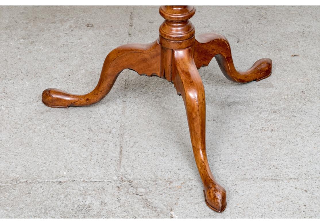 Fine 19th Century Philadelphia type Tilt Candle Stand in glowing solid Cherry. The Table with particularly fine graining, elegantly turned support column, classic Birdcage support and sinuous  cabriolet leg with snake foot. 

The Candle Stand