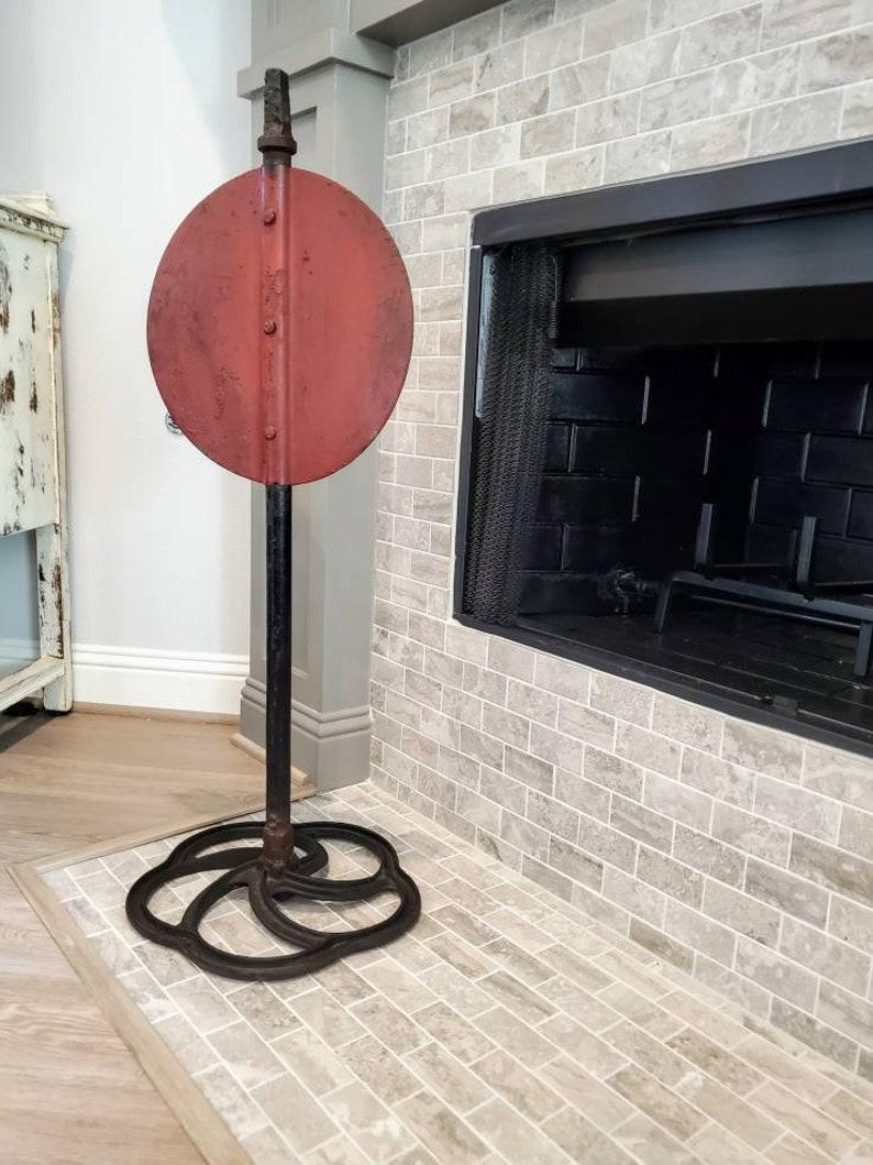 An antique American railroad yard switch sign on custom stand. A wonderful example of both Americana and industrial folk art! 

Born in the US in the early 20th century, the large, double sided, painted red iron circular disc shaped 