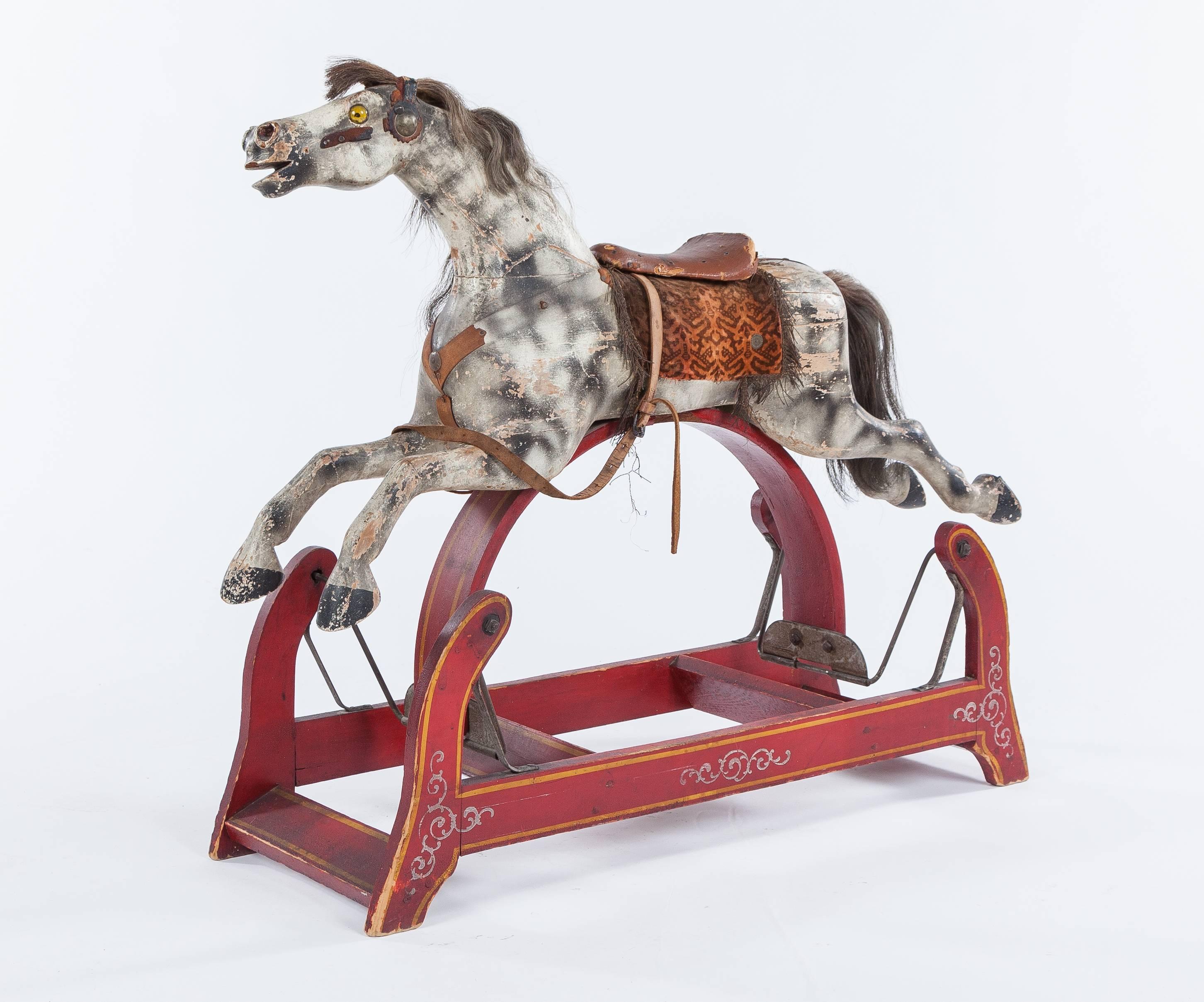 An American antique rocking horse dating to the mid-19th century. The rocking horse measures approximately 37