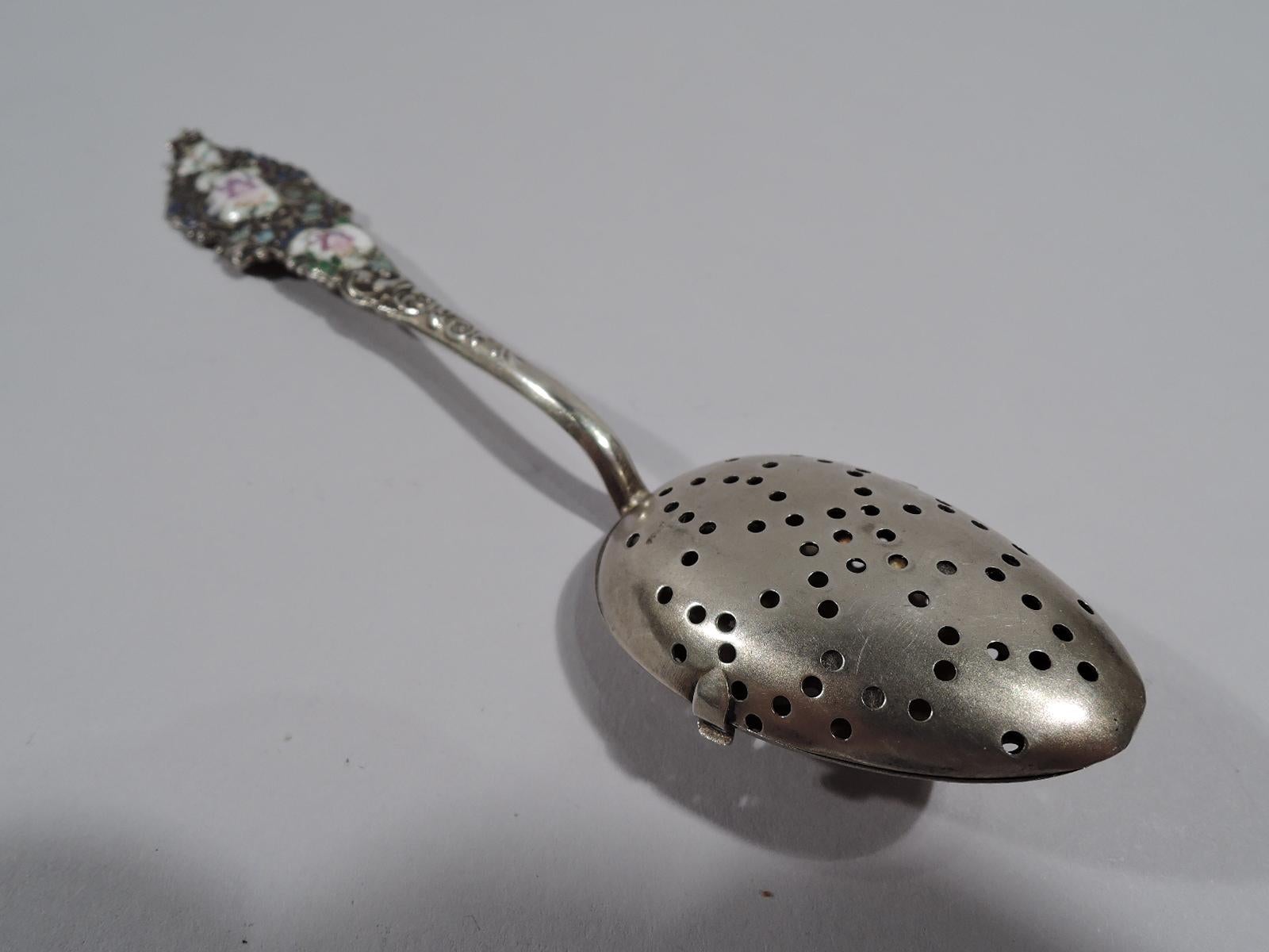 American Rococo gilt sterling silver and enamel tea infuser, circa 1890. Pierced oval bowl with hinged same cover. Scrolled and tapering shaft and terminal with enameled flowers and leaves. Terminal reverse engraved with script monogram. Marked