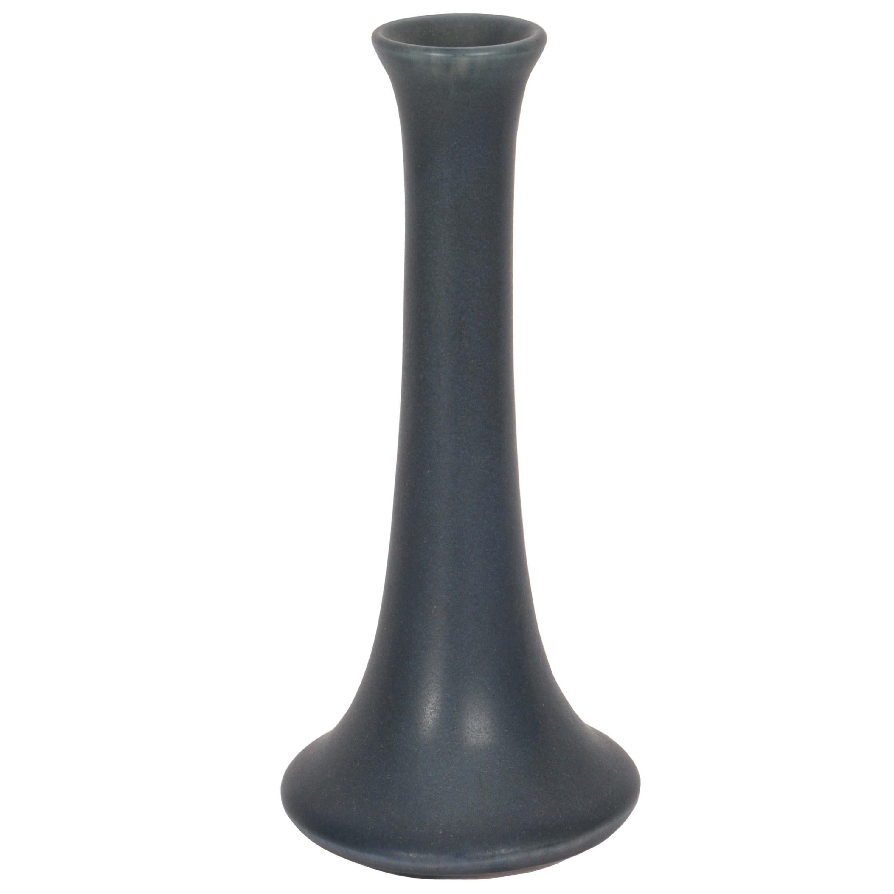 A good antique American Arts and Crafts pottery vase by Rookwood Pottery Co, dated 1917.
The vase having a charcoal color matte glaze with hints of green and blue, the vase of narrow tapering form with a flared foot, marked to the base with the