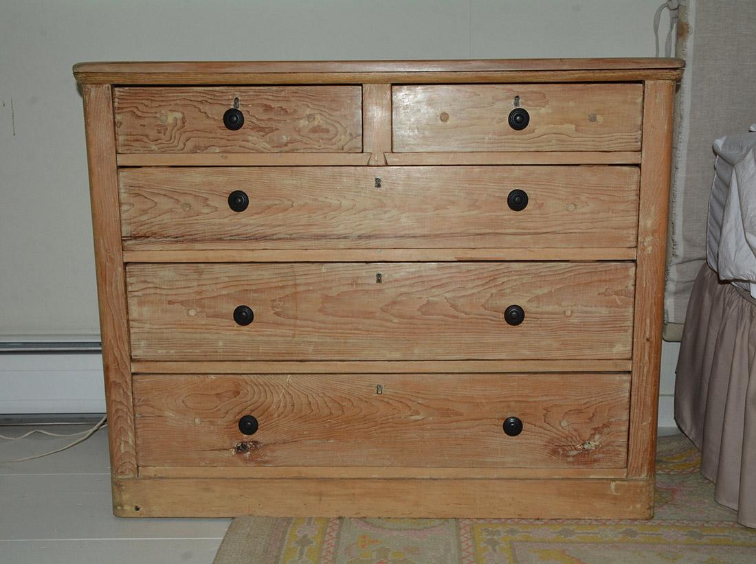 The antique scrubbed American country style rustic light pine chest has three large drawers and two side-by-side smaller drawers. Once was painted but has since been removed but can still see some paint remnant in various areas. Use either in a