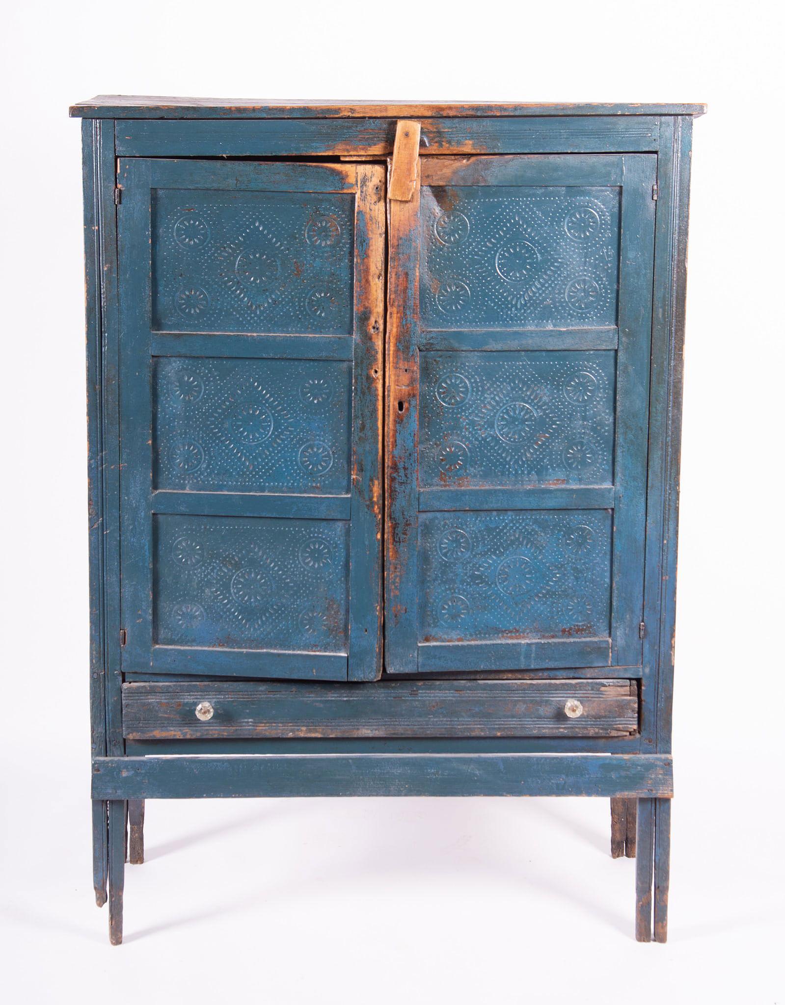 Antique Original Blue Paint Punched Tin Pie Safe cabinet. Cupboard doors with two interior shelves over a single drawer.

Dimensions
58