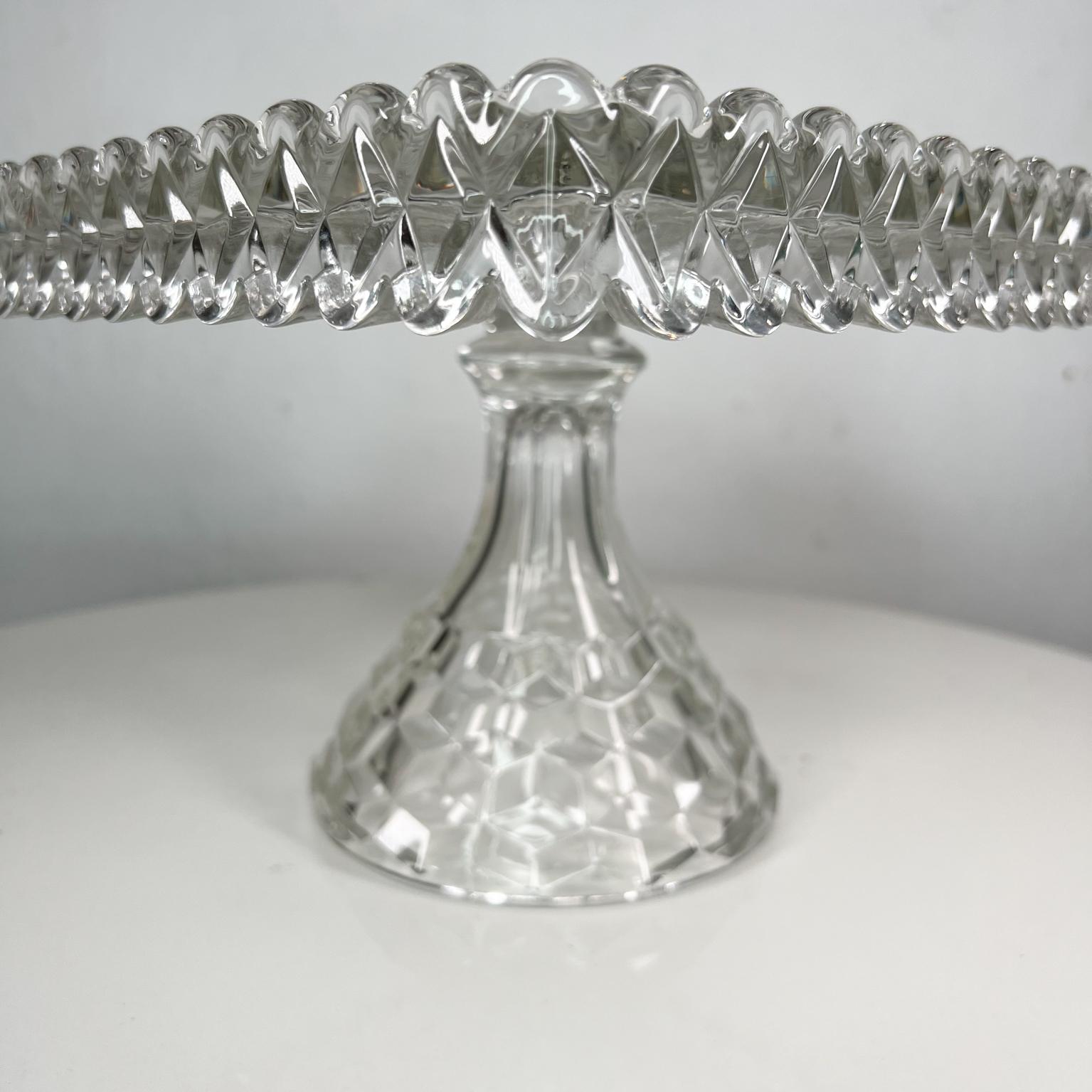 Antique Vintage Fostoria American series clear Stem square Cake stand 
Pedestal Base, Rum well and Ruffled edge
Measures: 10 x 10 x 7.25 tall
Preowned original vintage condition.
Review images provided.

