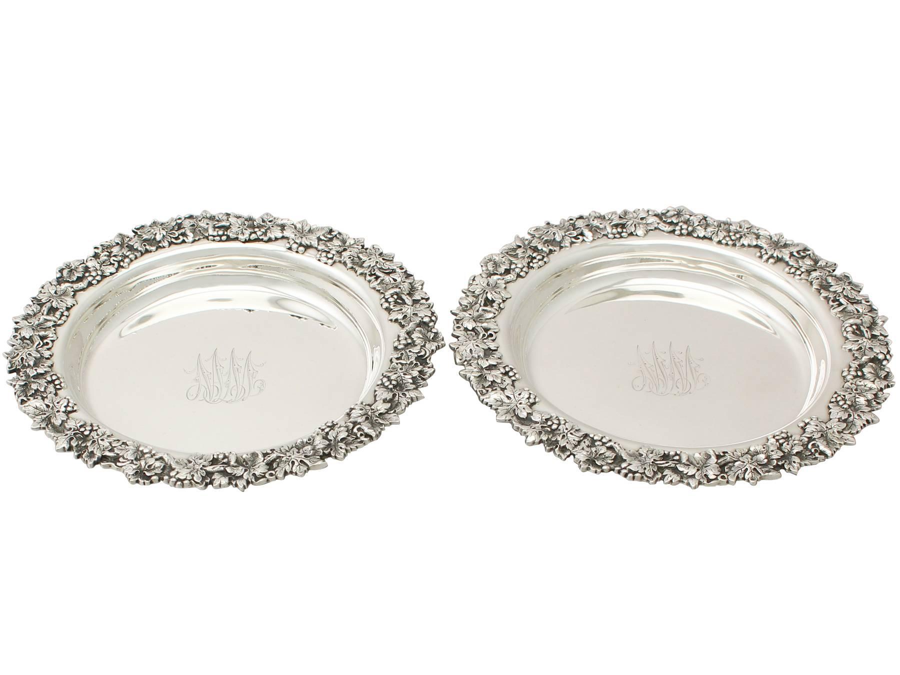 An exceptional, fine and impressive pair of antique American sterling silver coasters; an addition to our range of wine and drink related silverware.

These exceptional antique sterling silver wine coasters have a circular rounded form.

The