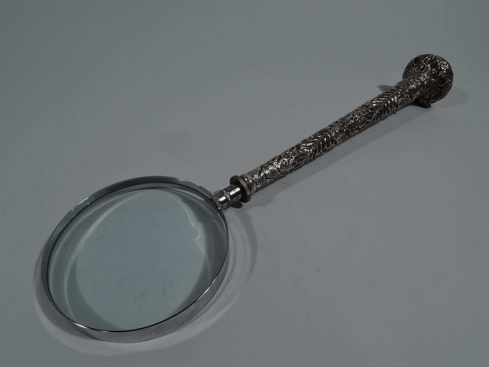 Antique American sterling silver magnifying glass, circa 1900. Long tapering handle with allover floral repousse. Circular mono plate (vacant) at handle end. Circular lens in stainless steel frame. A great desk accessory. Hallmarked.