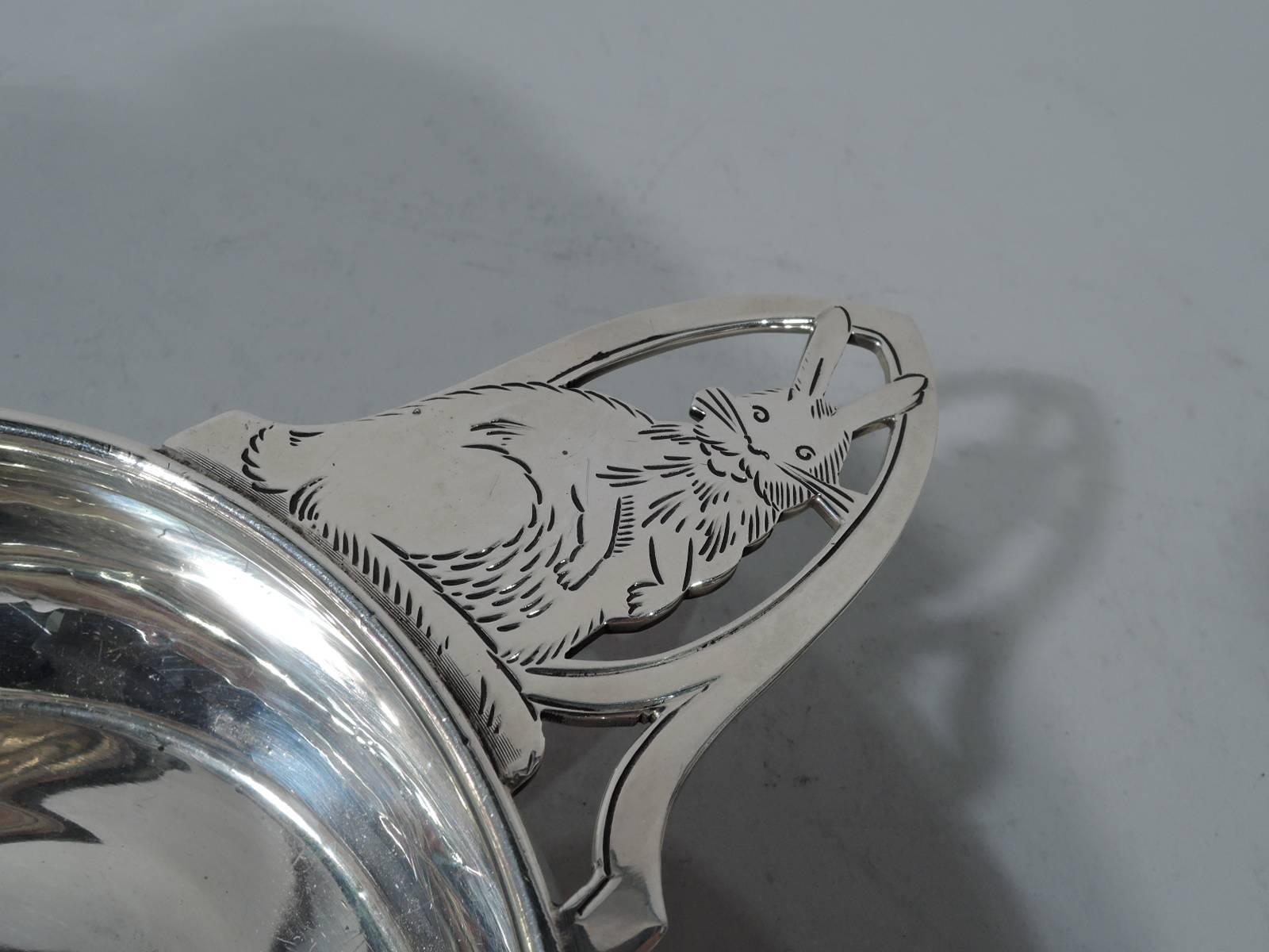 Sterling silver porringer. Made by Watrous (a division of International) in Wallingford, Conn., ca 1930. Curved sides and open handle inhabited by sweet rabbit: Bunny sits on haunches with limp forearms and erect pointy ears. Engraving brings out