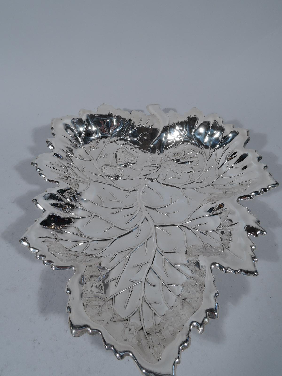 American sterling silver bowl, ca 1920. Leaf-form with spiky irregular tips and raised veins as well as a couple strawberries on leafing stems. Rests on 3 ball supports. A fresh and pretty serving dish. Marked “Sterling” with unidentified maker’s