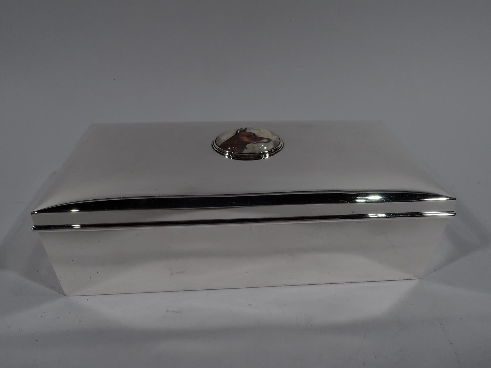 American sterling silver box with hunt motif, circa 1930. Rectangular with straight sides. Cover hinged and gently curved; mounted to cover top is Essex crystal depicting a fox in profile. Box interior cedar lined. Cover interior gilt washed. Fully