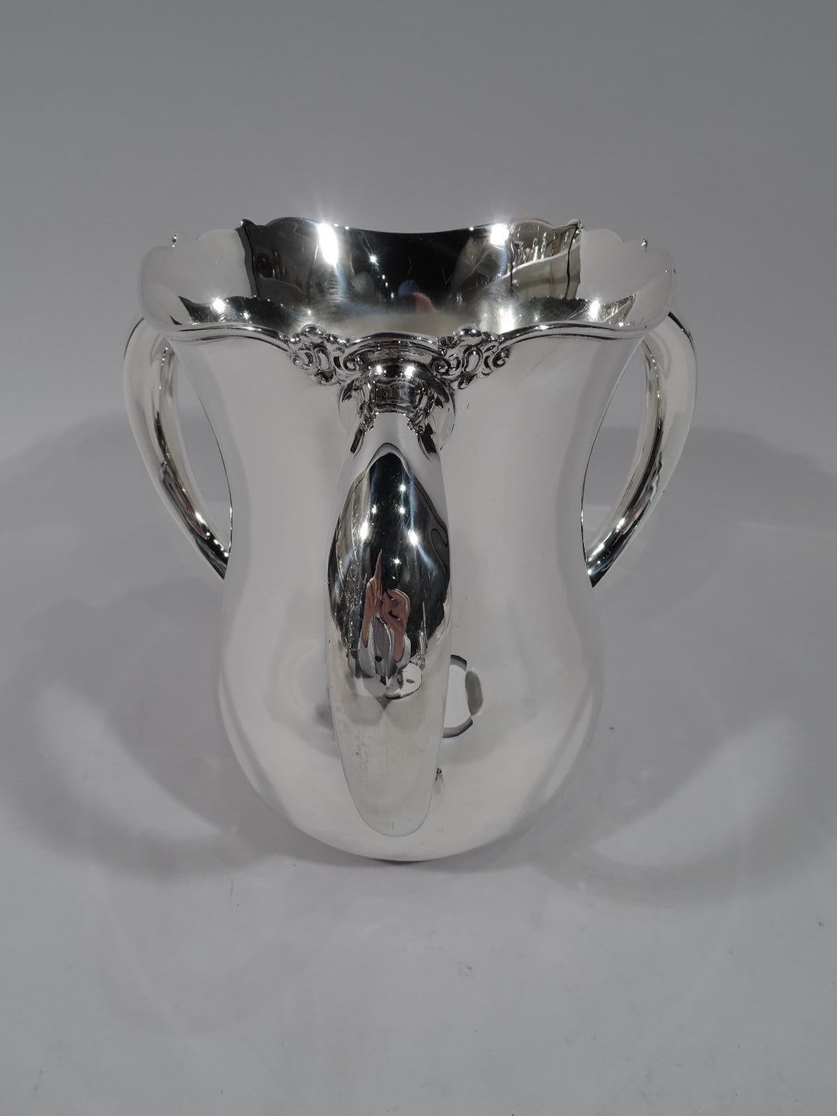 Turn-of-the-century American sterling silver loving cup. Traditional baluster with 3 C-scroll handles and molded wavy rim interspersed with scroll bunches. Lots of room for engraving. Fully marked including maker’s stamp (Fuchs), no. 1660, and