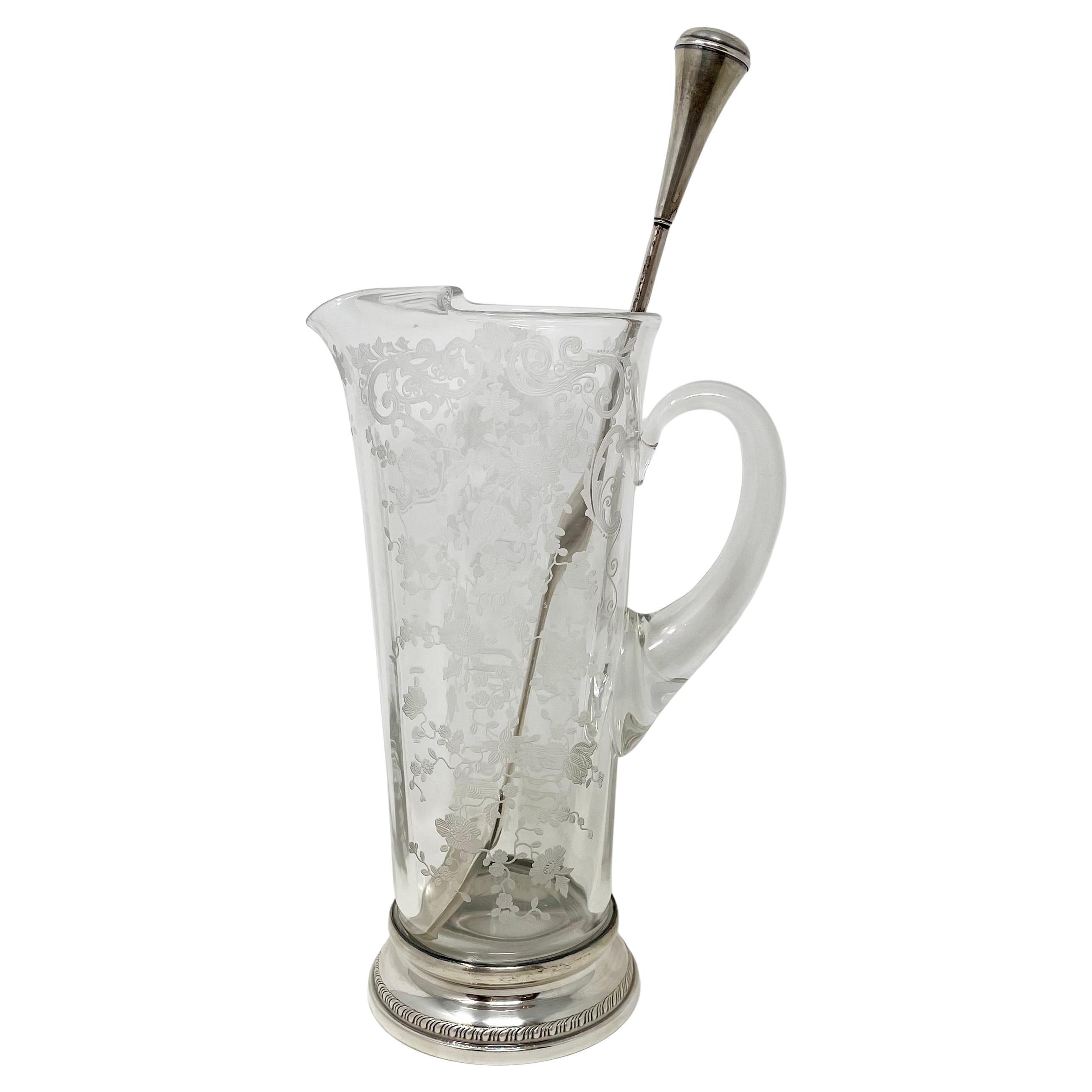 Antique American etched cut crystal cocktail pitcher with sterling silver mounts & sterling silver stir spoon.
Pitcher:
9 1/2