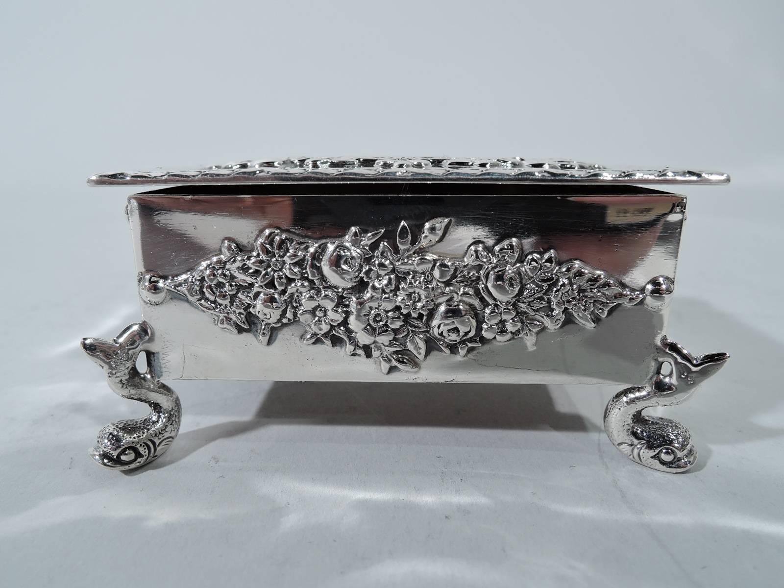 Pretty sterling silver postage stamp box. Made by Durgin (late part of Gorham) on Concord, New Hampshire, circa 1890. Rectangular with straight sides and flat hinged cover. Box interior gilt and partitioned with curved bottom. Applied ornament: