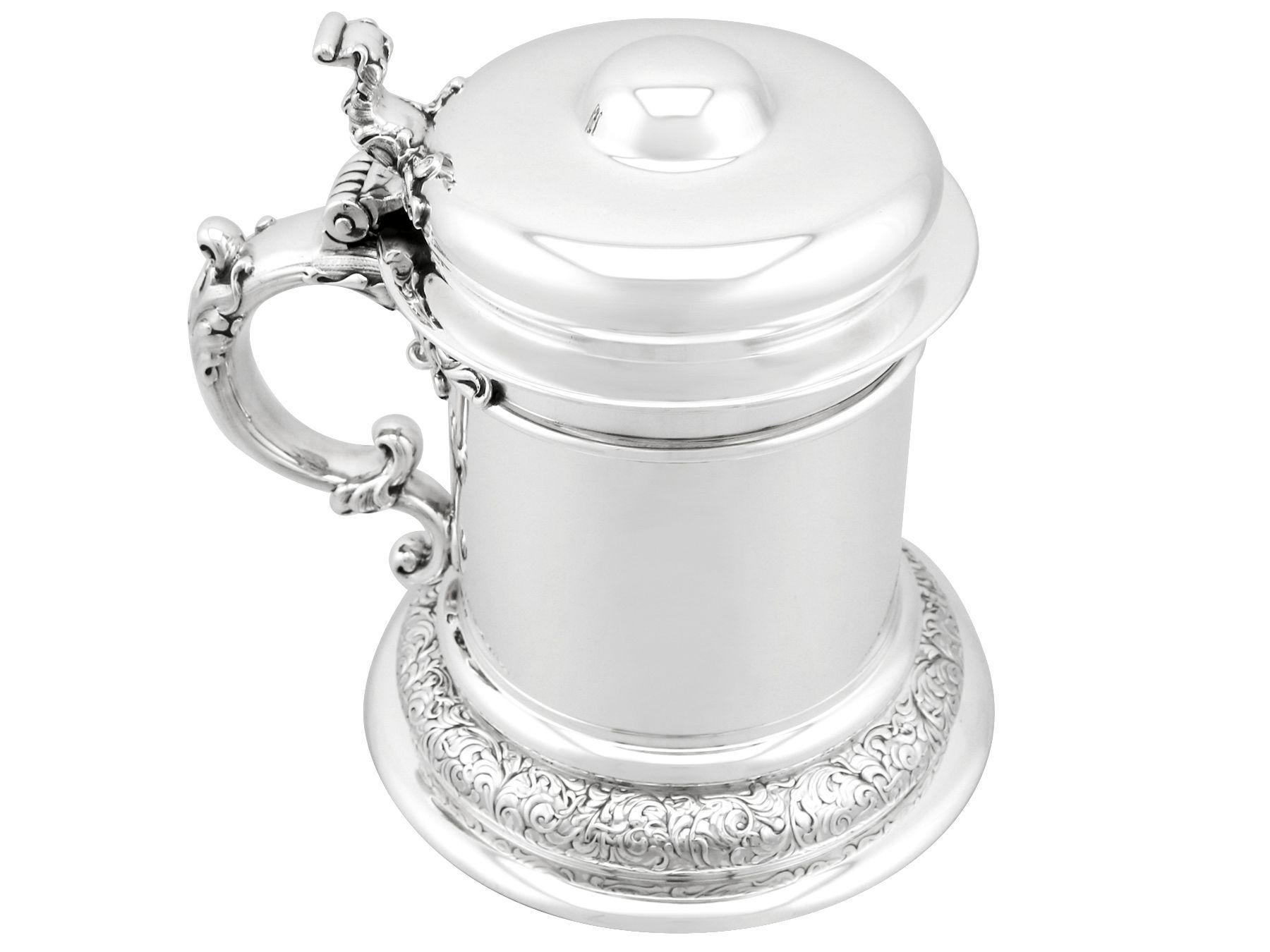 An exceptional, fine and impressive antique American sterling silver quart tankard; an addition to our range of collectable silverware

This exceptional antique American sterling silver tankard has a plain tapering cylindrical form onto a circular