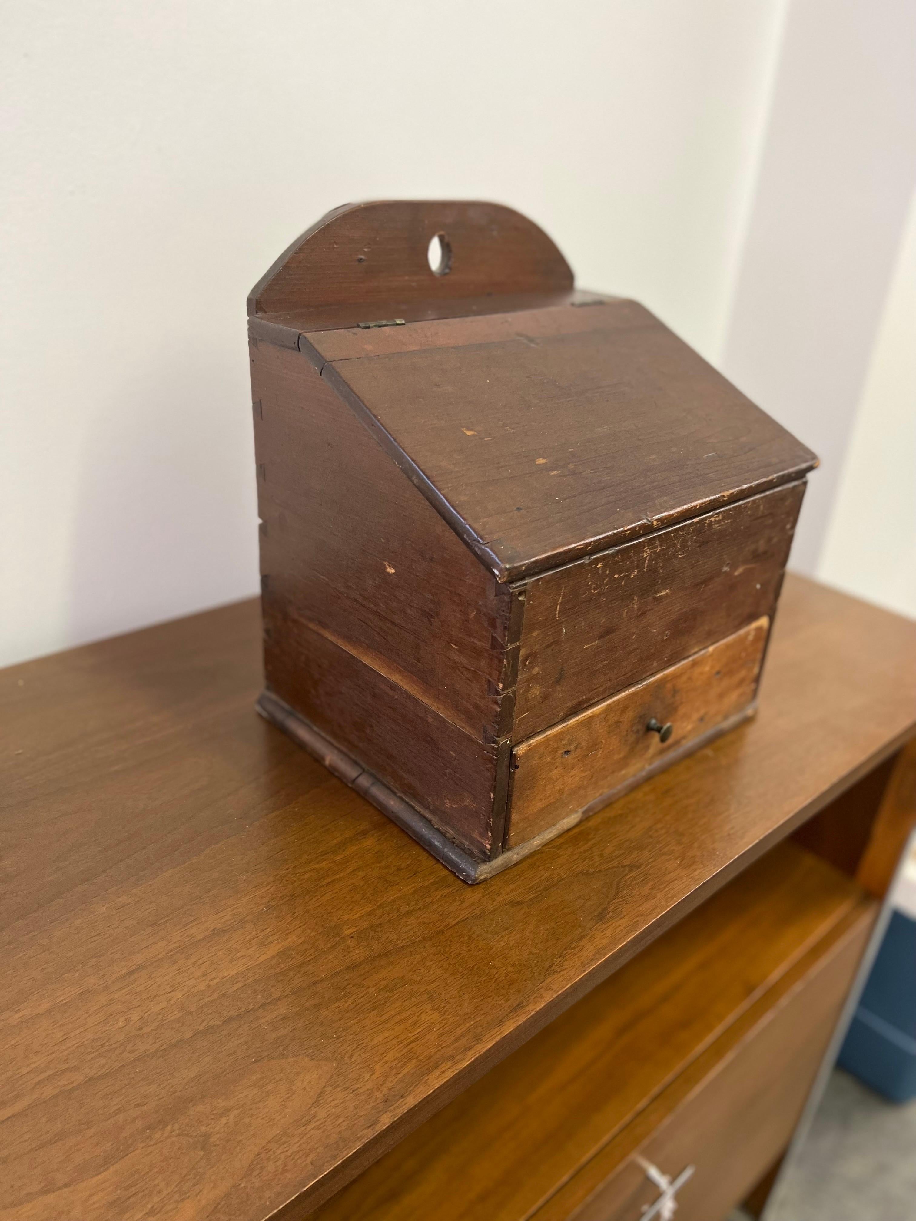 Antique Shaker Spice Box

Offered is a unique antique Shaker spice box. The piece is from the 1800’s. The piece features a lift up lid as well a single drawer. The drawer is divided to keep your different spices separated. The box is dovetailed in