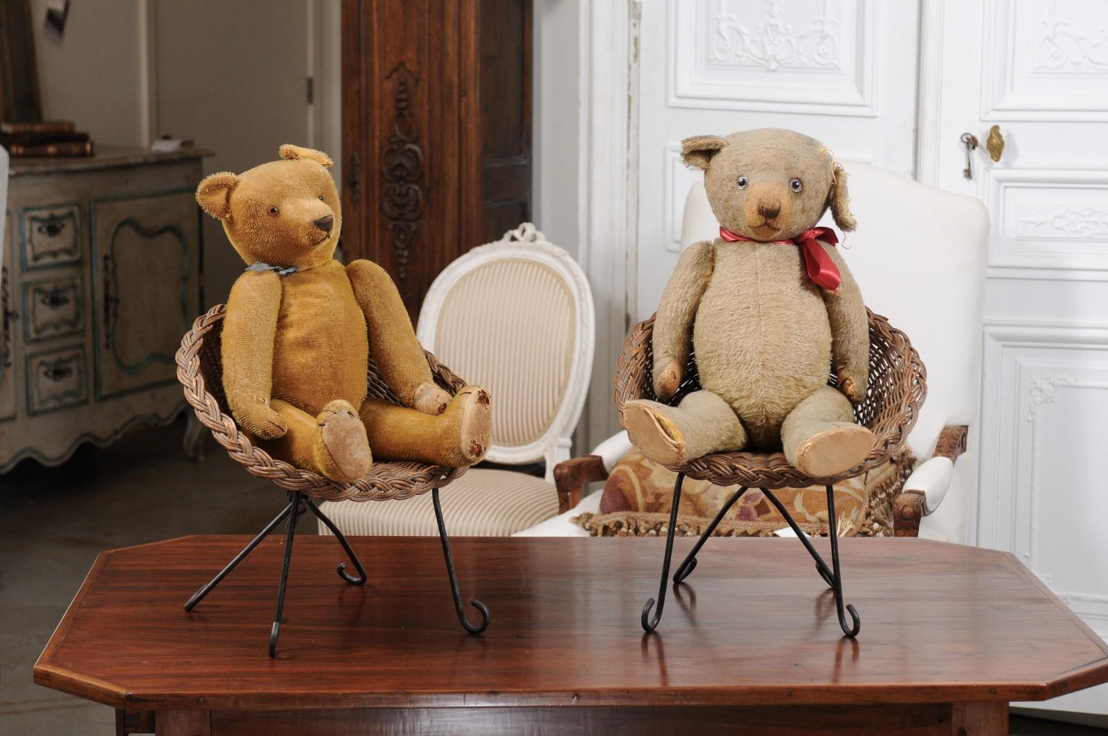 Two antique American teddy bears from the 20th century sitting in wicker chairs, priced and sold individually $495 each. Made in the USA during the 20th century, each teddy bear melts our hearts with its nicely weathered appearance revealing its