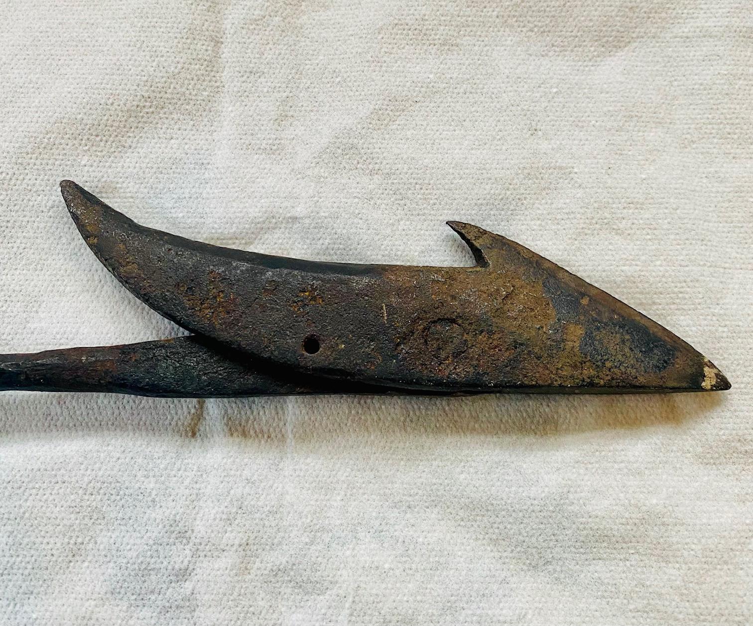 Antique American Toggle Iron Harpoon, circa 1880, having an improved toggle head with sharply angled acute barb, and a markedly upswept rear barb, with possibly a ship's mark S _, mounted on a round shank ending in an unusually long socket with an