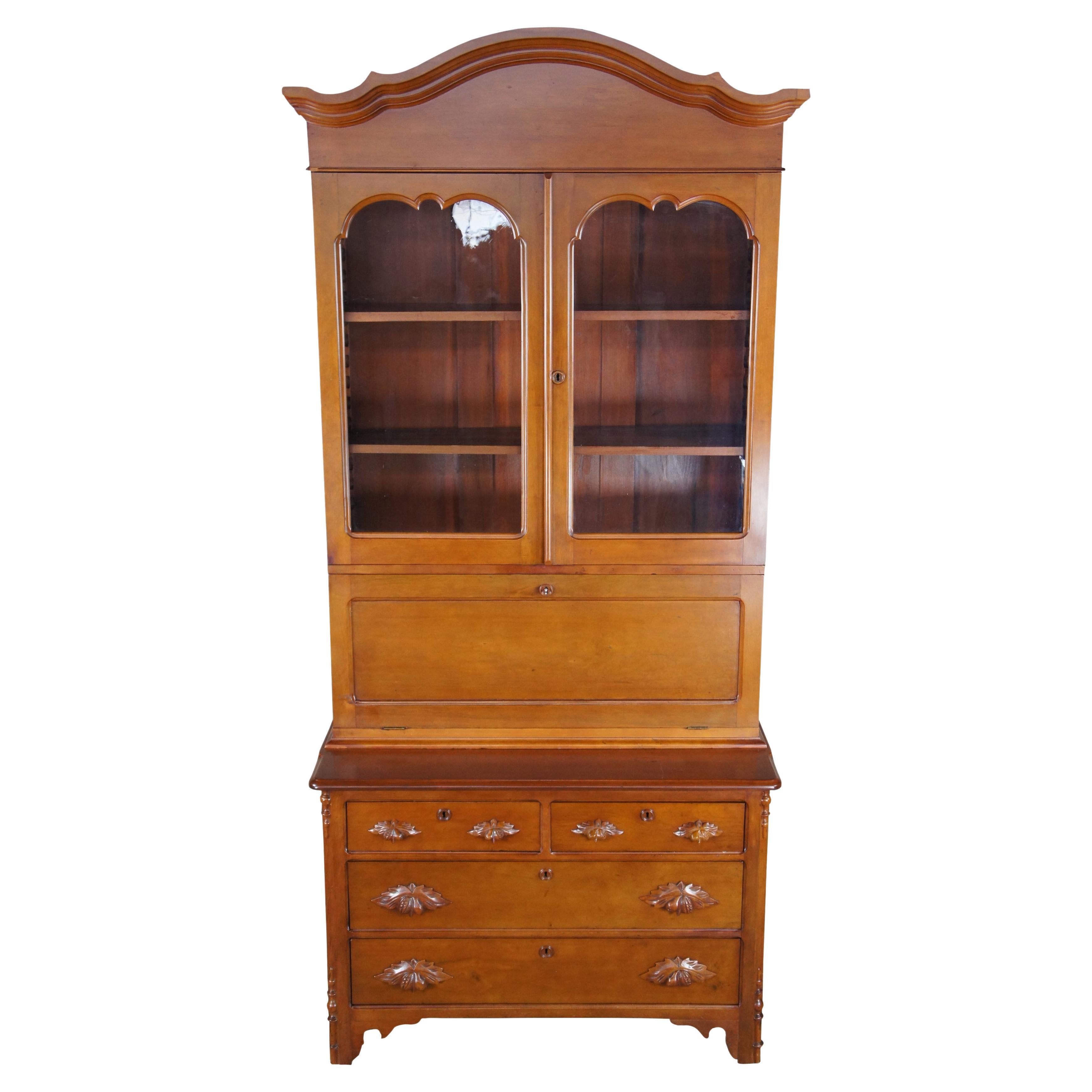 Antique American Victorian fall/ drop front secretary desk, bookcase, hutch and curio. Made of solid cherry featuring rectangular form with upper bookcase curio that retains original wavy glass, central drop front secretary desk with multiple