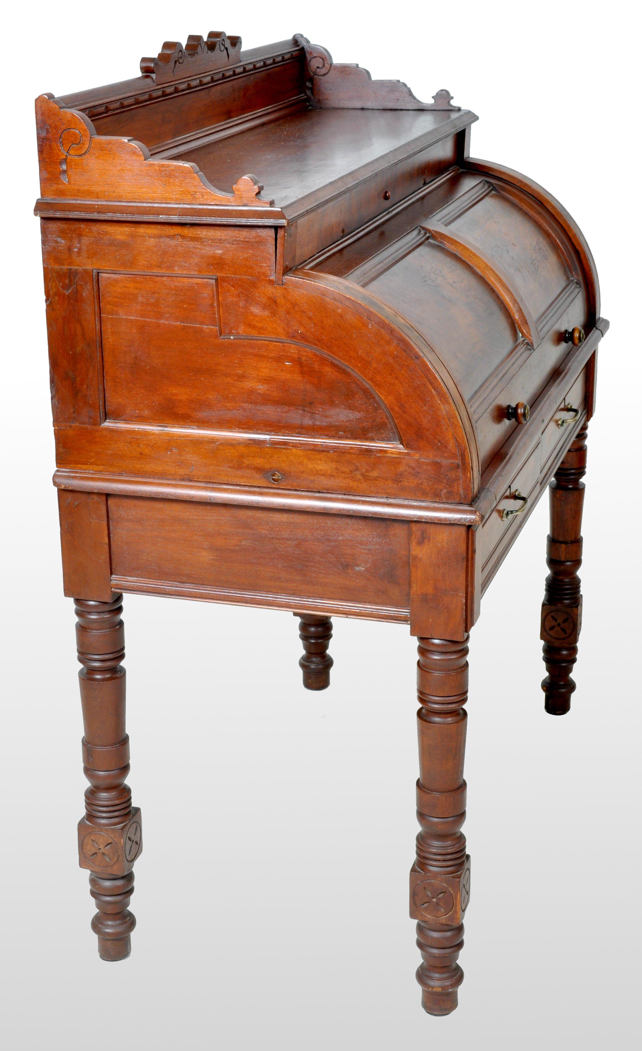 Antique American Eastlake walnut cylinder roll-top desk, 1875. The desk having a carved gallery, below is a cylinder roll-top having burl walnut panels. Inside is a fitted interior with a pull-out writing surface, below a pair of drawers with brass
